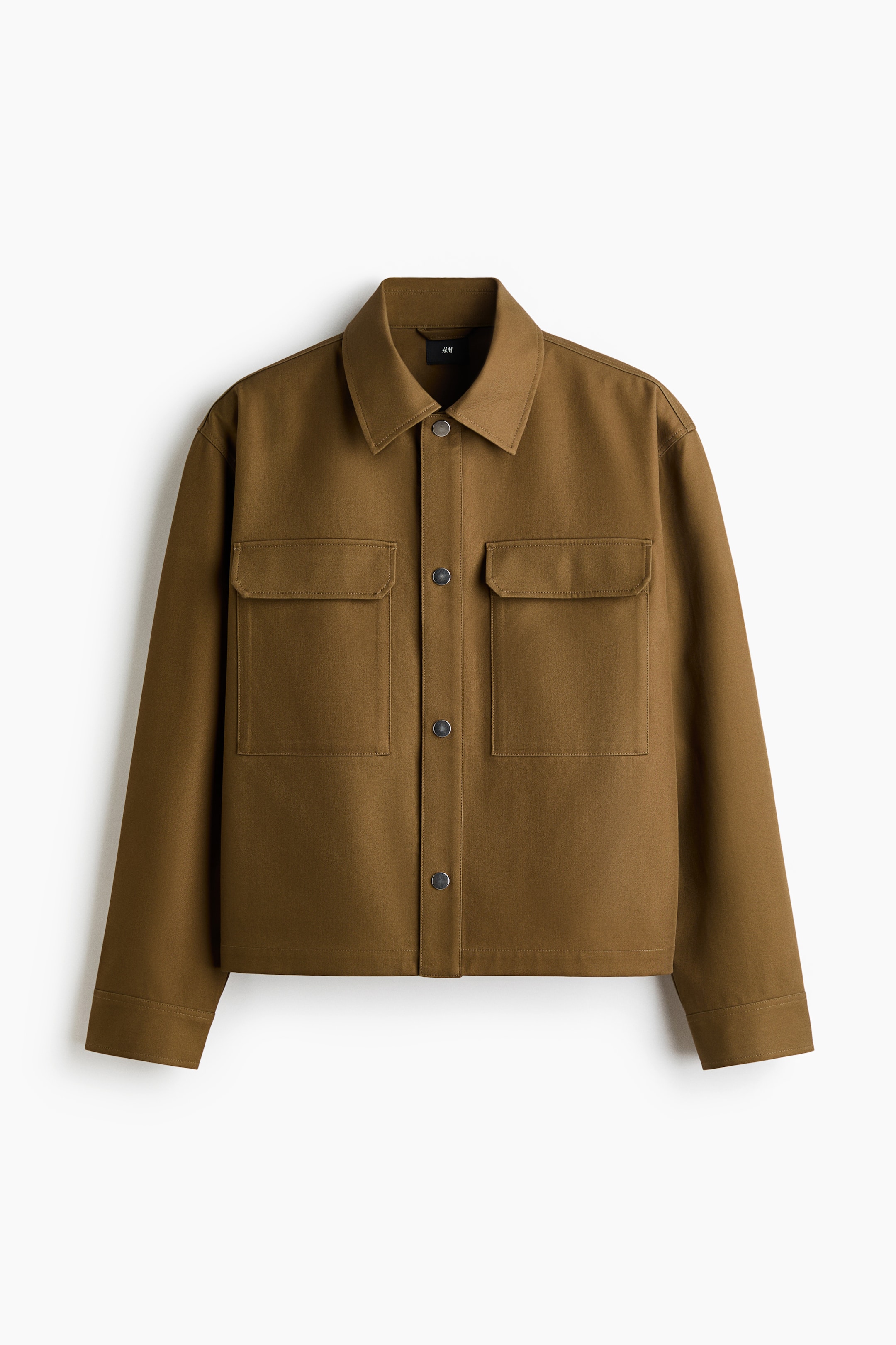 View larger image: A brown jacket is showcasing its front, featuring a pointed collar, a button-up front closure with dark buttons, and two large patch pockets on the chest, while also displaying long sleeves with straight cuffs.