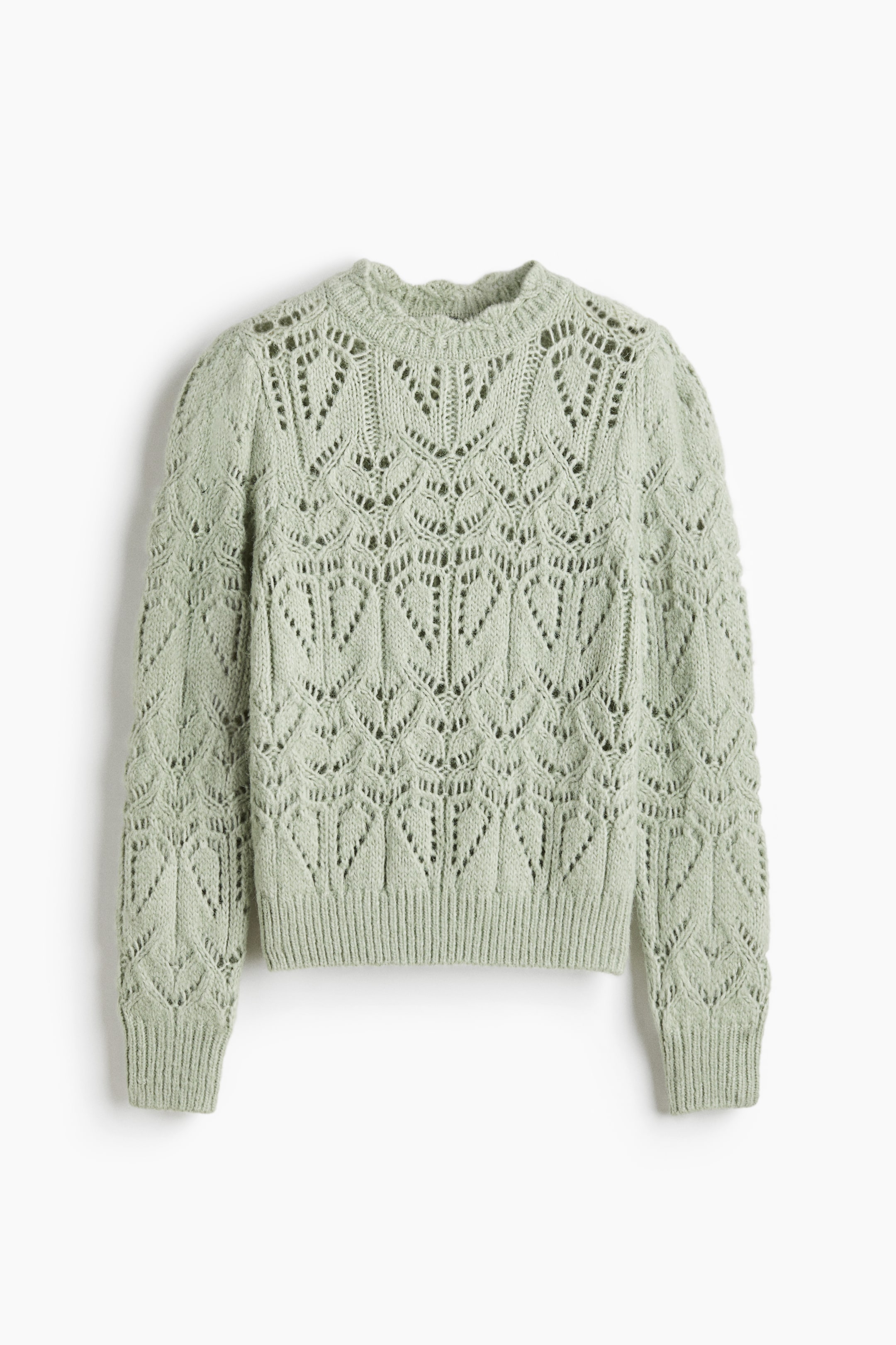 View larger image: A light green knitted sweater is displayed front-facing, showcasing an openwork pattern of repeating leaf-like motifs across its body and sleeves. It features a ruffled round neckline and ribbed cuffs and hem.