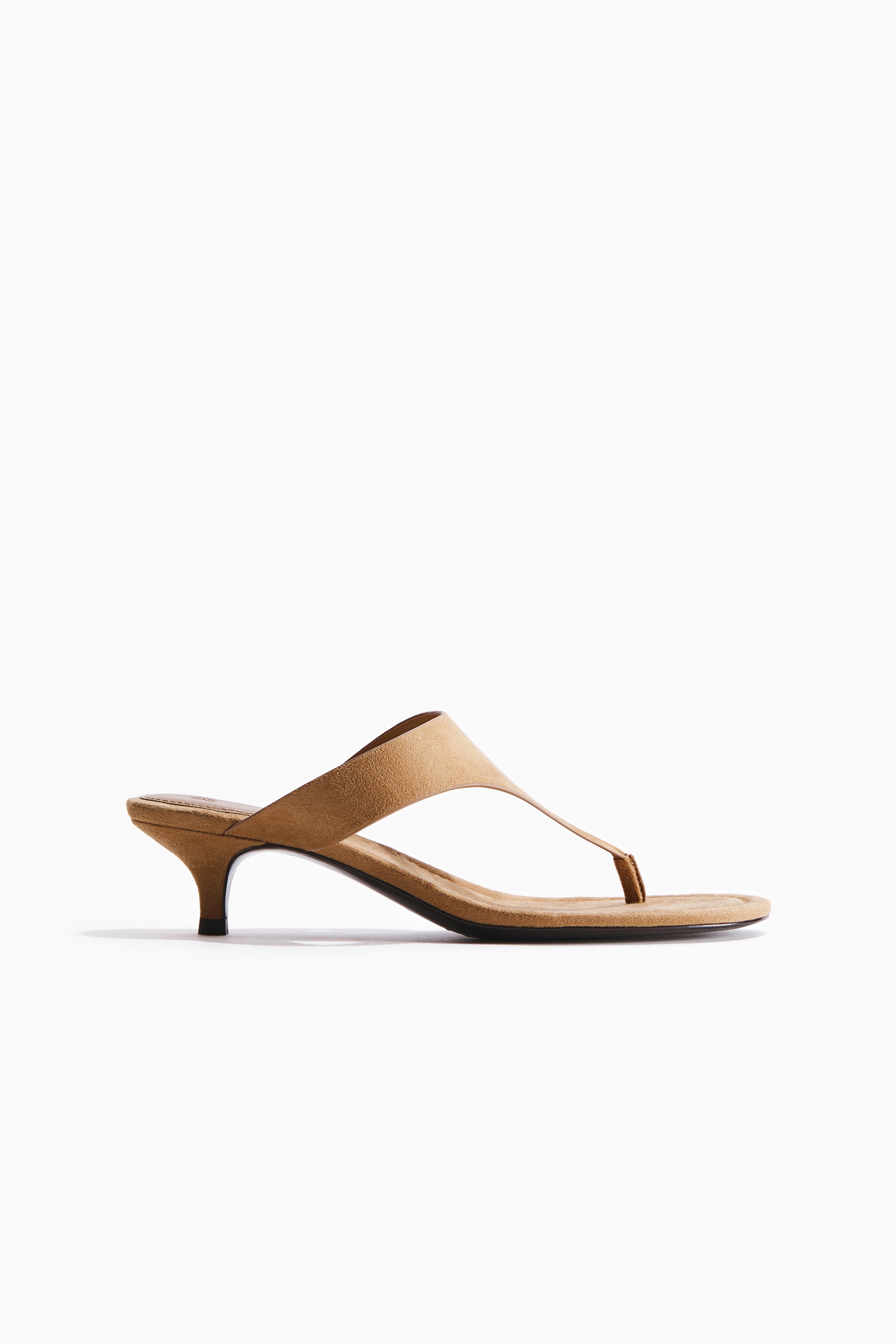 View larger image: Sandals feature a soft, napped finish, oblique toes, a narrow foot strap and toe post, and partially covered kitten heels.