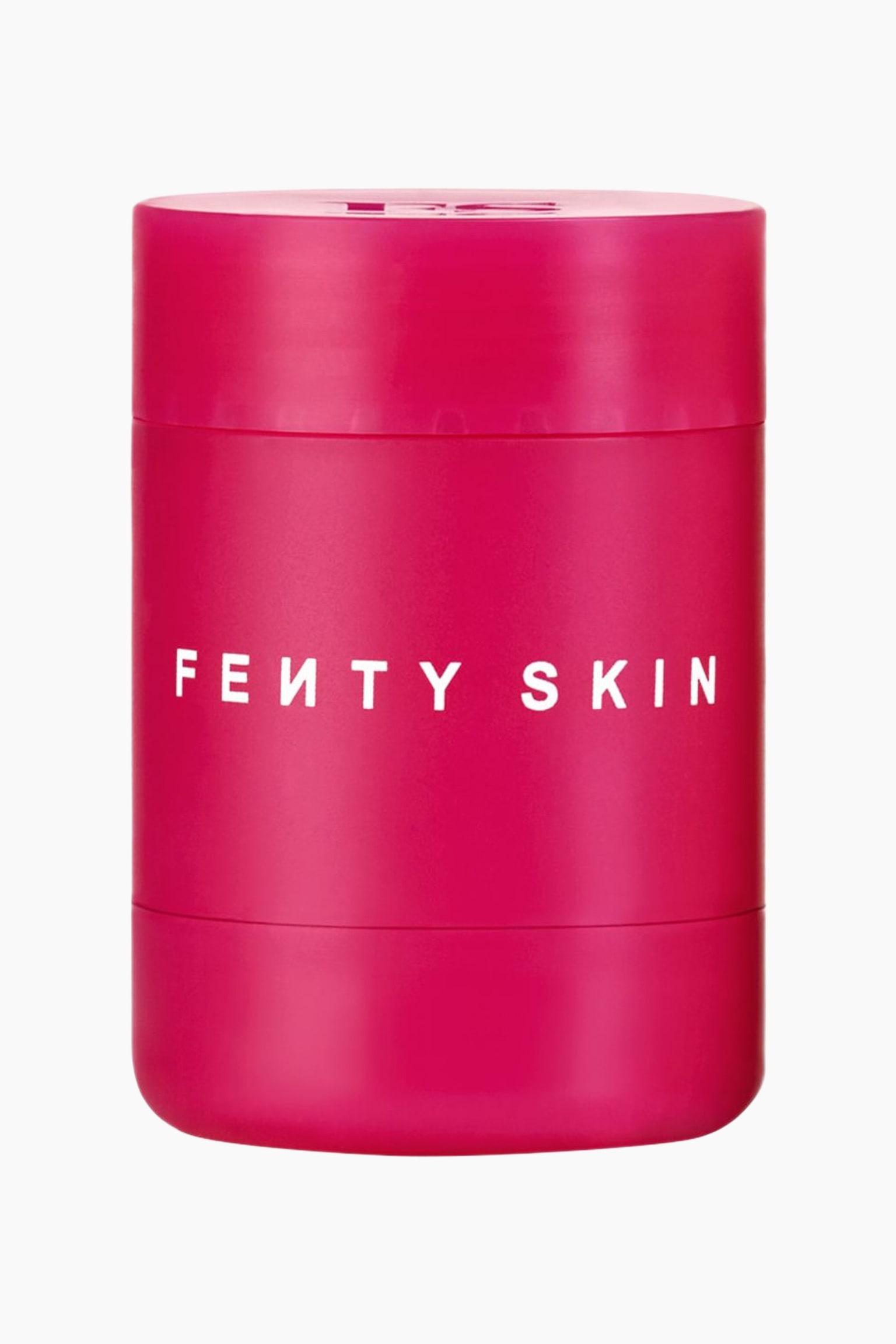 SylinterimÃ¤inen, magentaan vivahtava pinkki huulivoidepakkaus seisoo pystyasennossa ja on suunnattu eteenpÃ¤in. Pakkauksessa on brÃ¤ndin nimi "FE?TY SKIN" painettuna valkoisin suuraakkosin keskelle, ja twist-up-pakkauksen ylÃ¤- ja alaosassa nÃ¤kyy vaakasuorat saumat.