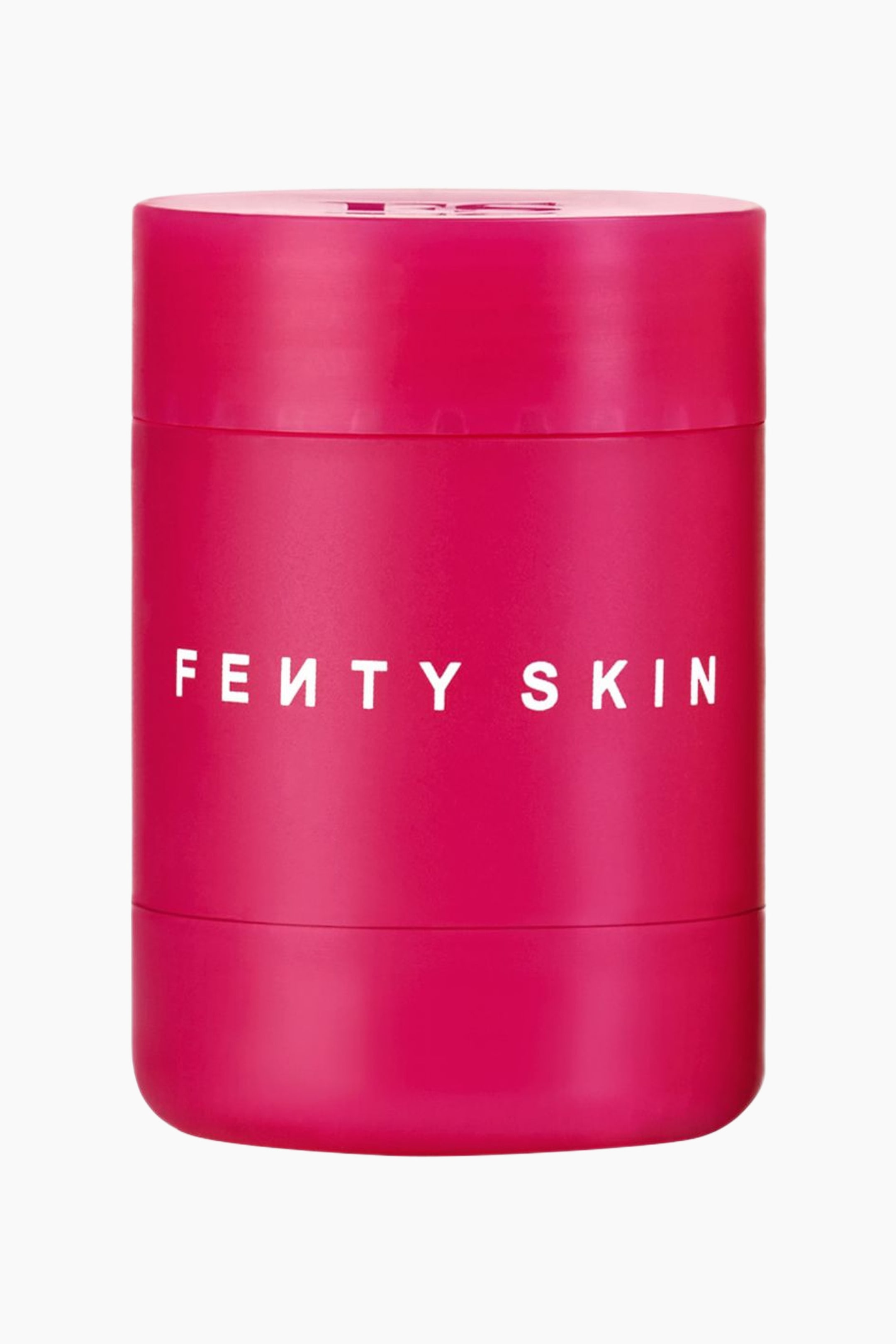 Visa större bild: En cylindrisk, magenta-rosa läppvårdsbehållare står upprätt och vänd framåt. Behållaren har varumärket "FE?TY SKIN" tryckt i vita versaler över mitten, med horisontella sömlinjer nära toppen och botten av den vridbara förpackningen.