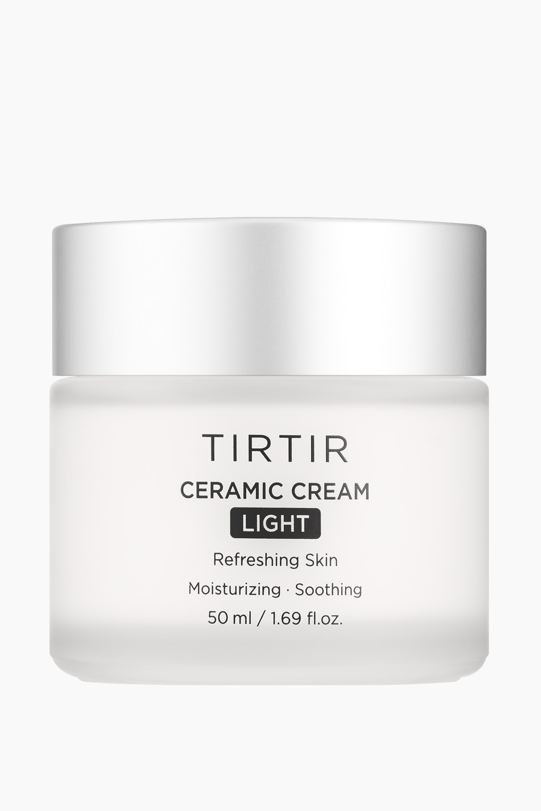 Vis større bilde: TIRTIR Ceramic Cream Light presenteres i en frostet hvit rektangulær krukke med avrundede hjørner, toppet med et sølvfarget sylindrisk lokk. På etiketten foran står det 'TIRTIR' og 'Ceramic Cream', med 'Light' i en svart rektangulær boks, etterfulgt av 'Refreshing Skin', 'Moisturizing – Soothing', og '50 ml / 1.69 fl.oz.' i svart tekst.