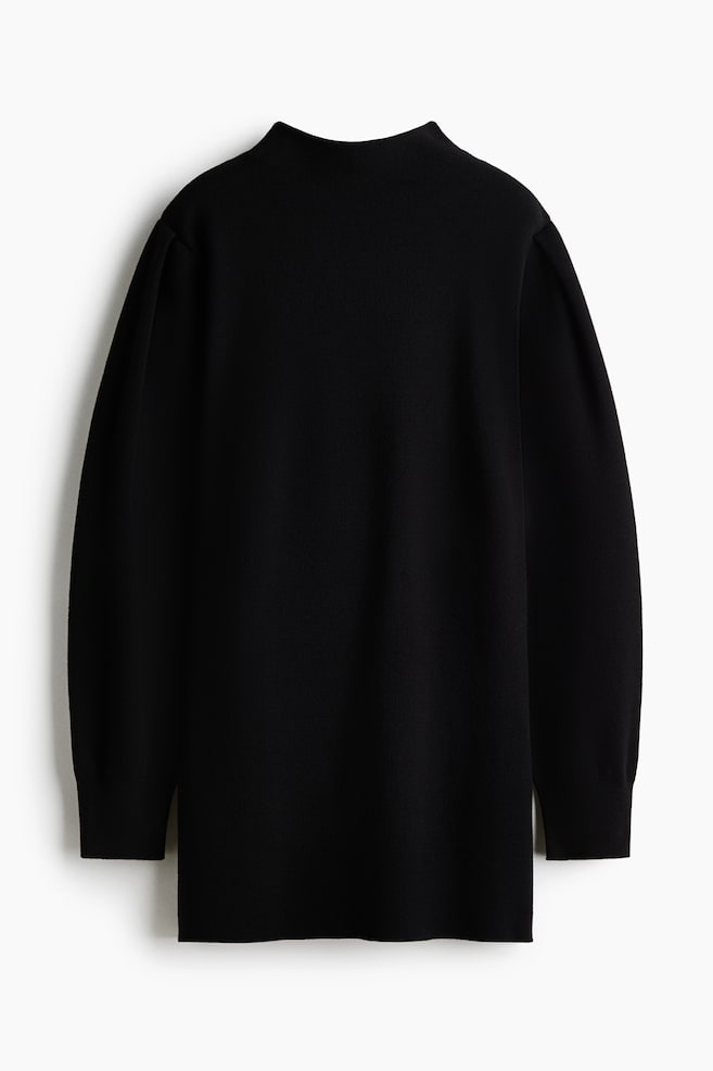 A black knitted jumper is shown from the front, featuring a high mock neck and a relaxed fit. It has long sleeves with gathered, puffed shoulders and ribbed cuffs. - 1