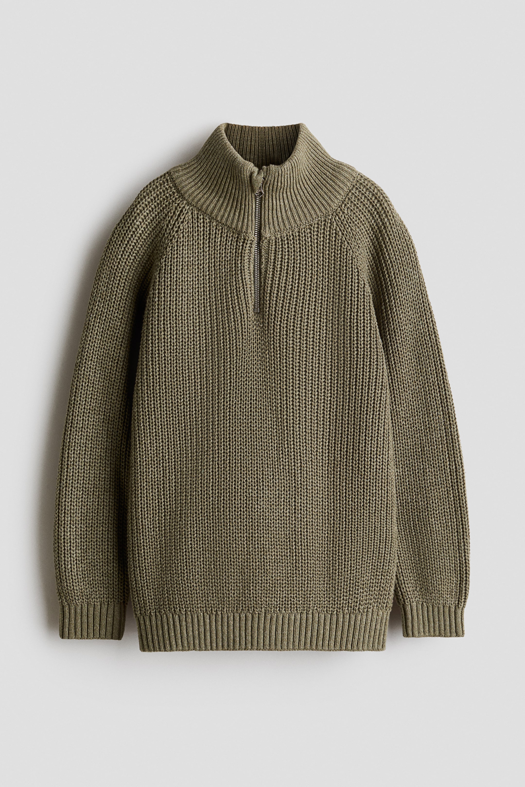 View larger image: An olive green H&M Adorables jumper is laid flat and shown from the front. It features a chunky knit texture, a ribbed stand collar with a half-zip closure, long raglan sleeves, and wide ribbing at the cuffs and hem.