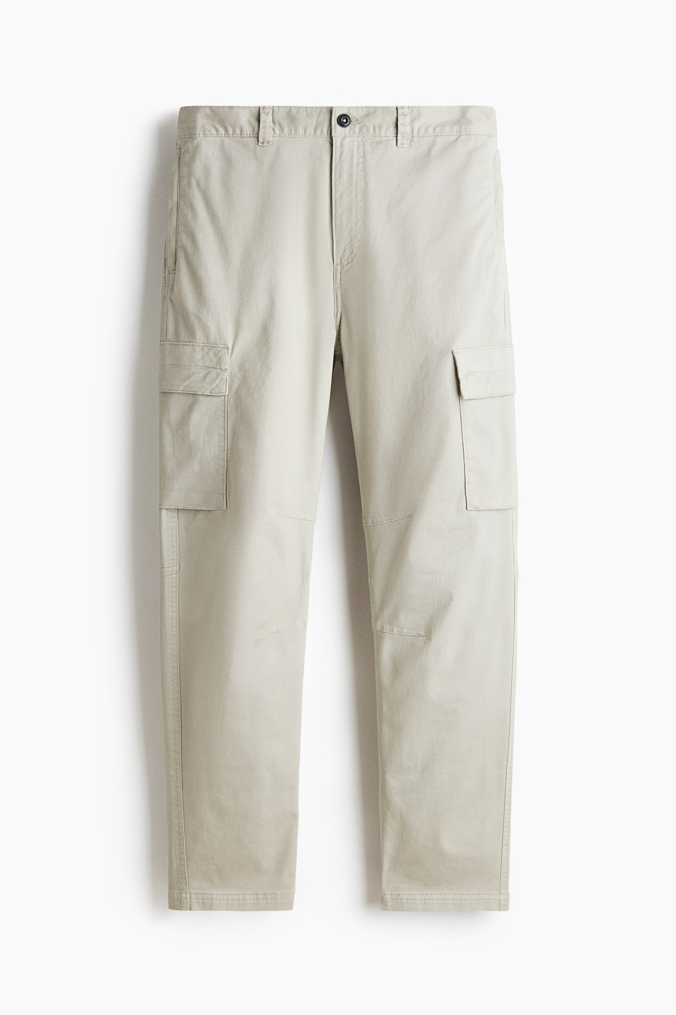 View larger image: Light beige cargo pants are displayed from a front view, featuring a waistband with belt loops and a button closure. Two flap cargo pockets are positioned on the sides of the thighs, and seaming details are visible on the knees.
