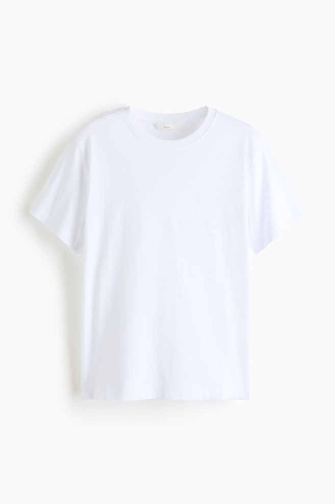 A plain white t-shirt is shown from the front, featuring a ribbed crew neck, short sleeves, and a straight hem. - 1