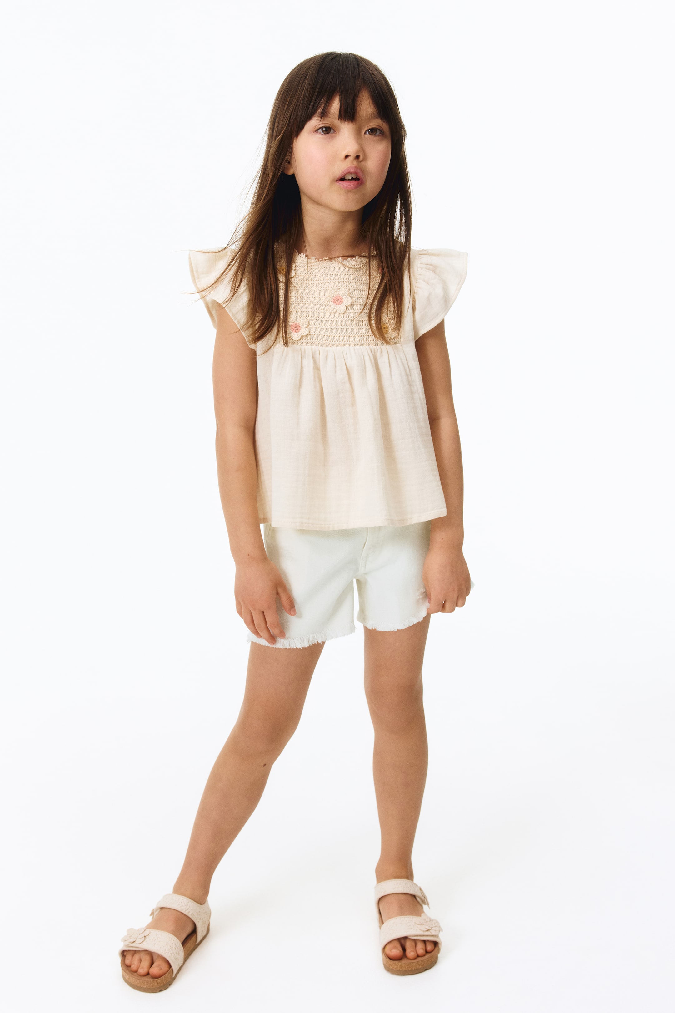 Short frangé en denim