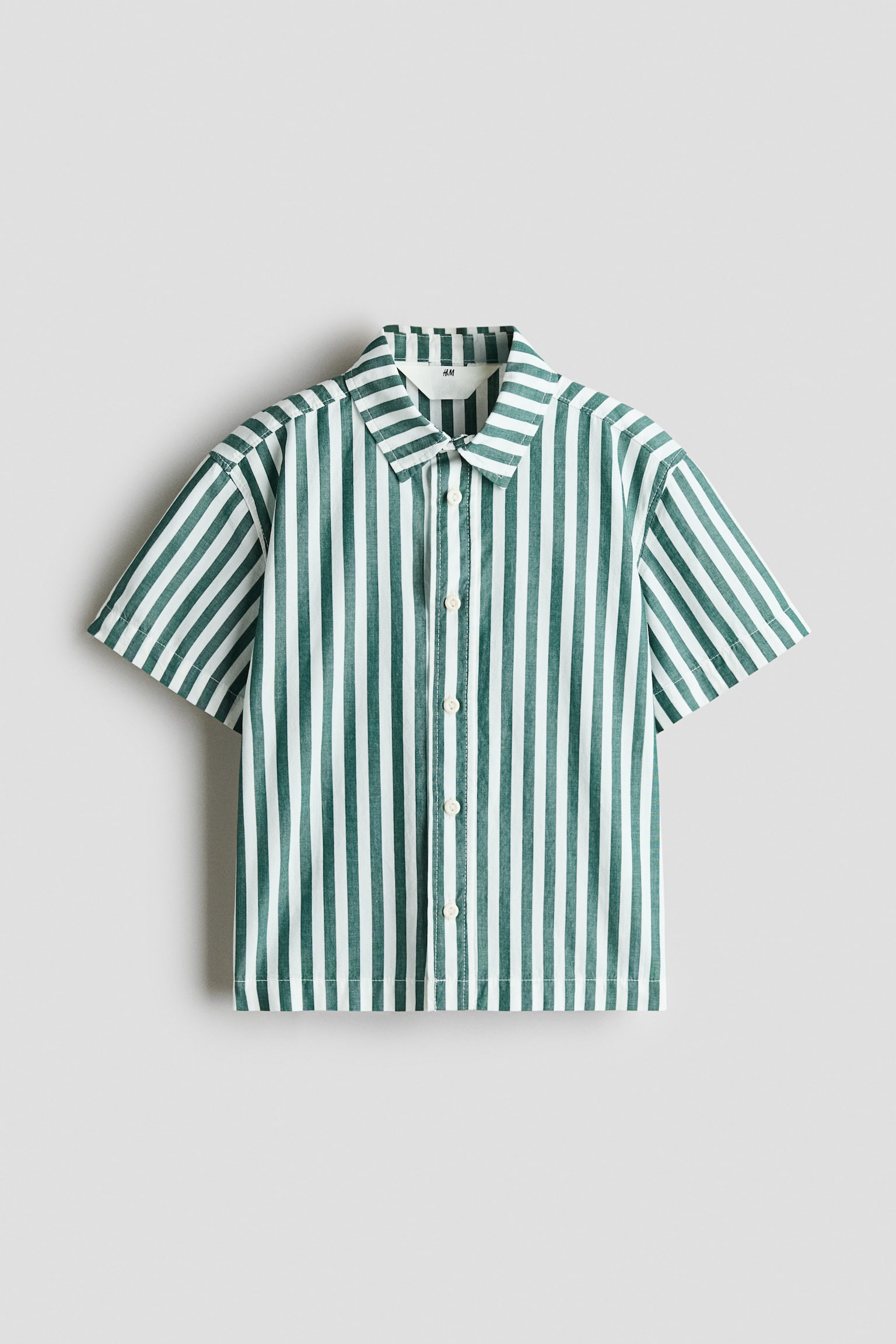 A short-sleeved, button-up shirt is shown from the front, featuring a vertical green-and-white striped pattern. The shirt has a classic point collar, a central button placket with white buttons, and a straight hem. - 1