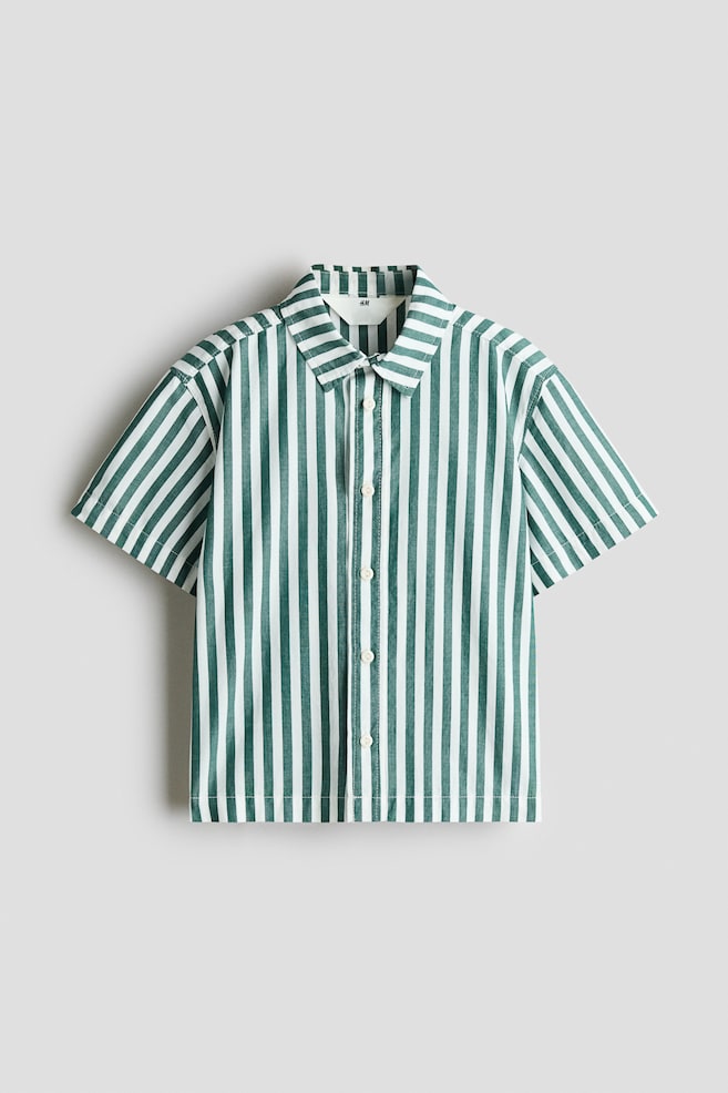 A short-sleeved, button-up shirt is displaying a vertical green and white stripe pattern from the front. The shirt is featuring a classic point collar, a central button placket with white buttons, and a straight hem. - 1