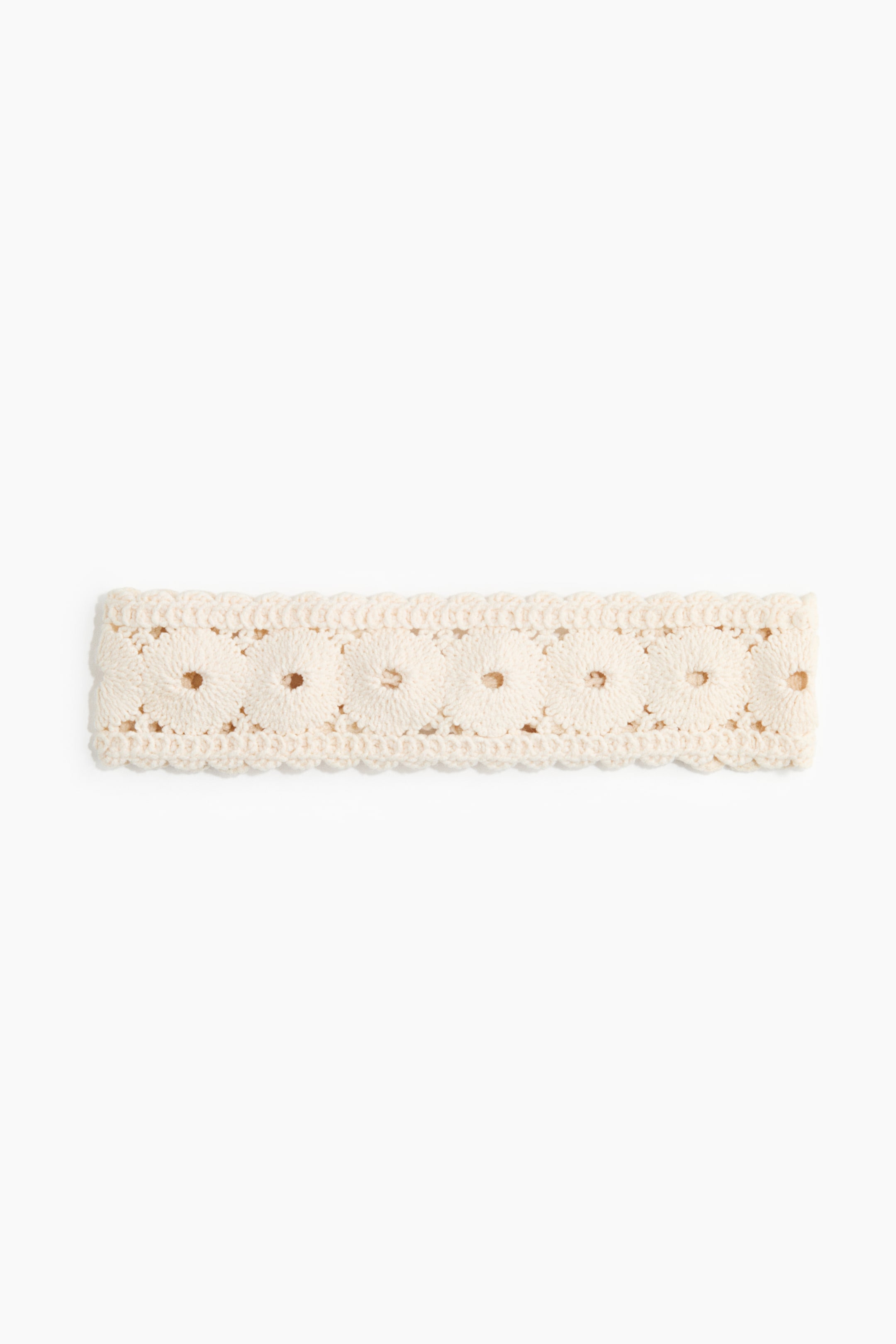 View larger image: A broad hairband displays a cream-hued crochet-style cotton knit, adorned with scalloped edges and a recurring design of circular motifs with tiny central openings.