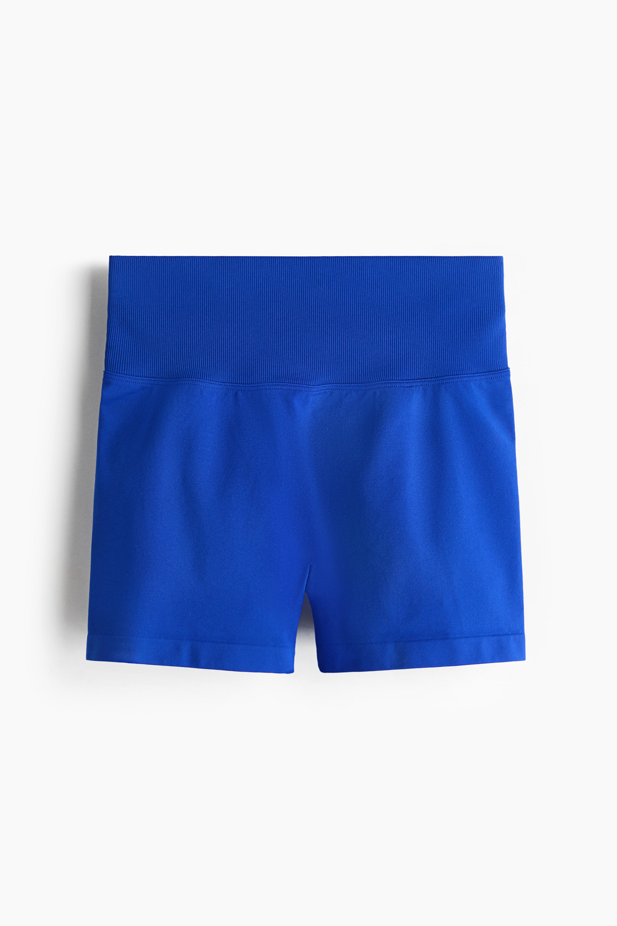 Visa större bild: Blå shorts har en bred, ribbad midja och en slät, sömlös kropp. De visas från en framsida.