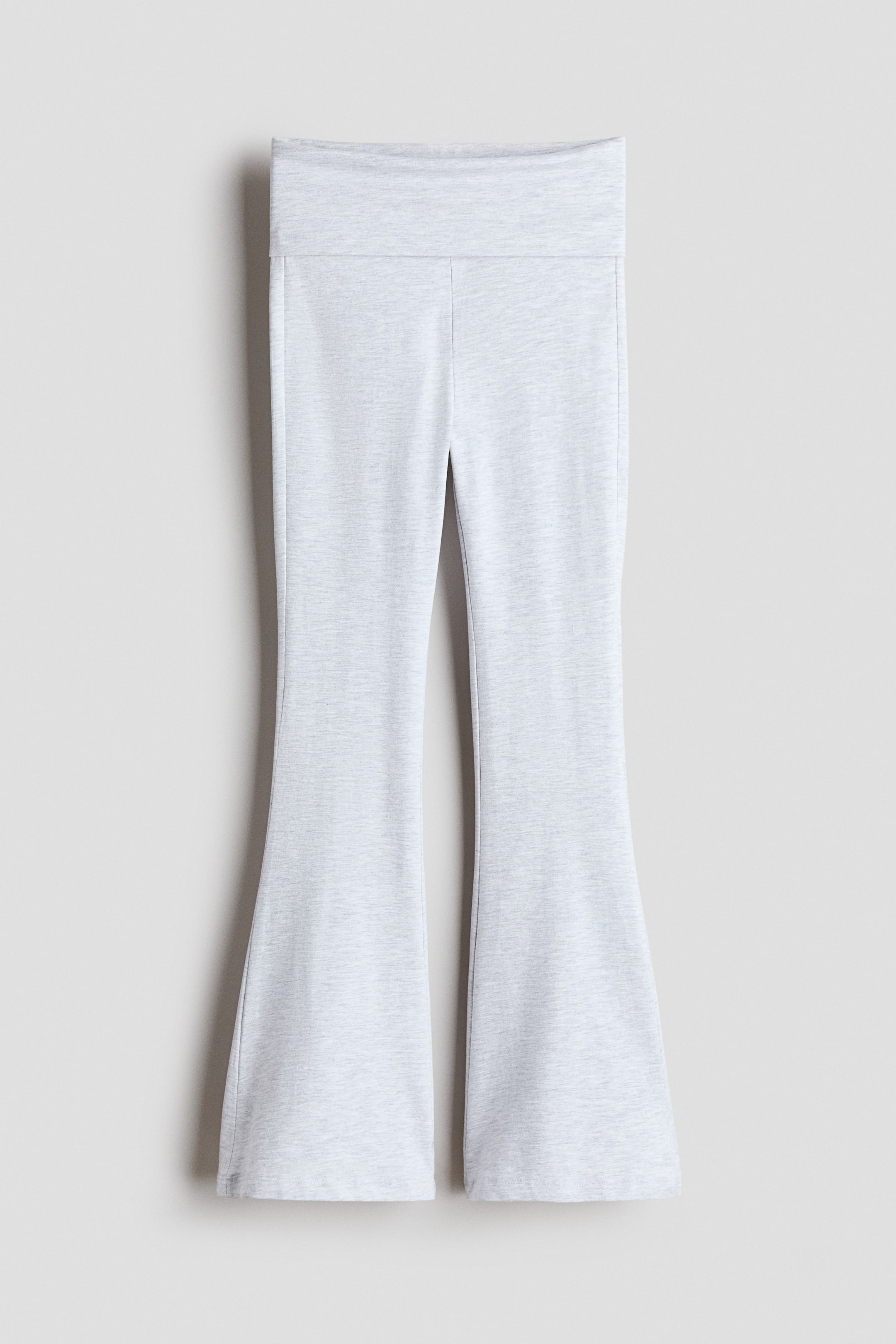 Visa större bild: Ljusgrå melerade utsvängda leggings visas framifrån, med ett brett, vikbart midjeband, där benen svänger ut från knäna ner till en utsvängd silhuett.