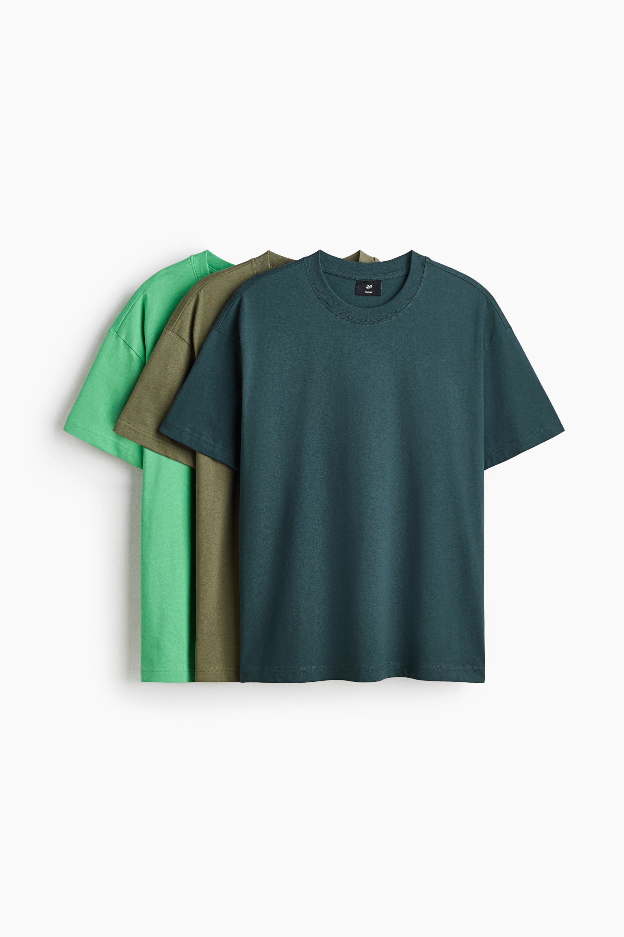View larger image: Three T-shirts are displayed, layered from light green to olive green to dark teal. The front dark teal T-shirt showcases a round, rib-trimmed neckline, short sleeves, and a straight-cut hem, offering a relaxed fit in midweight cotton jersey.