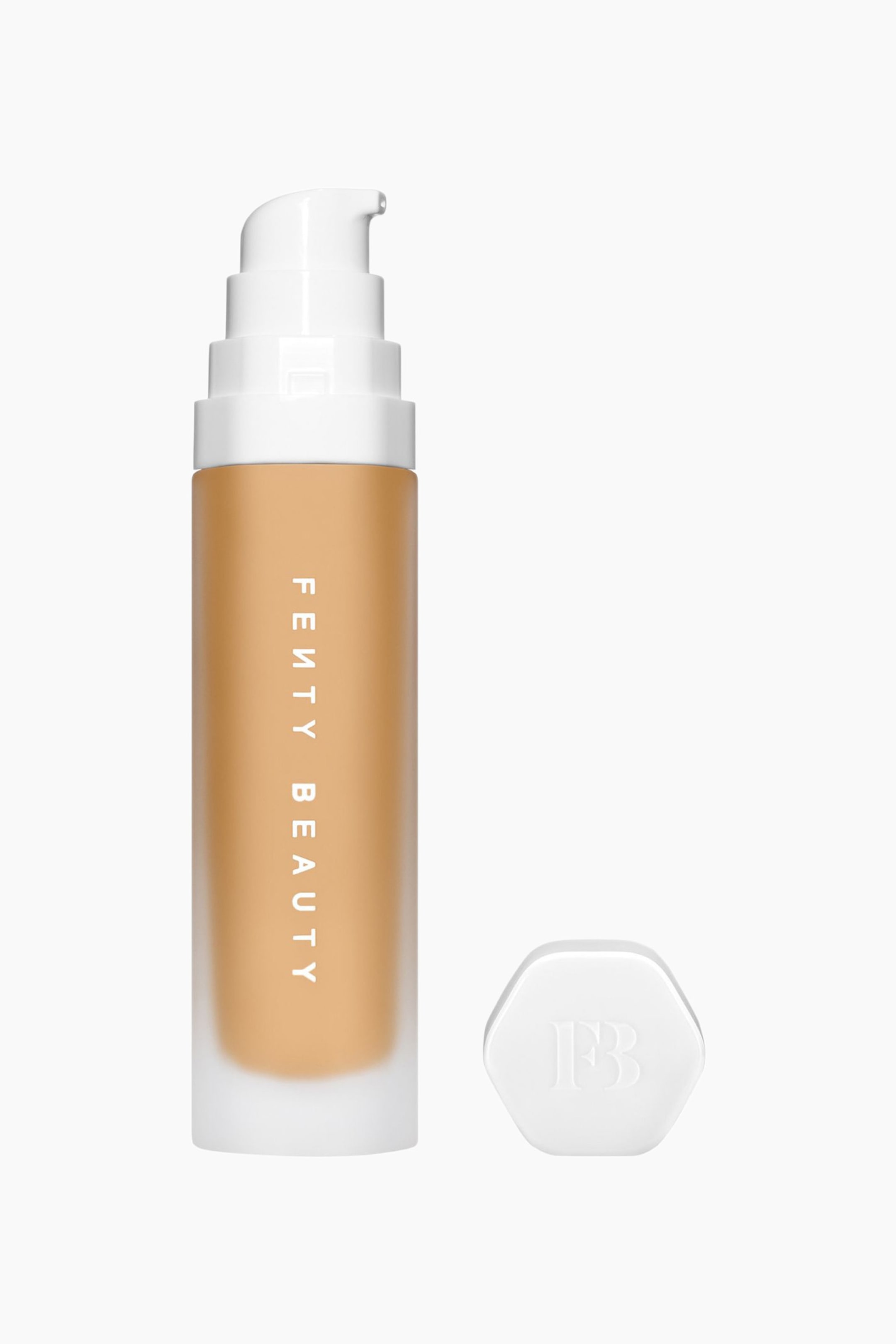 Visa större bild: Soft'lit Naturally Luminous Longwear Foundation står upprätt och visar en medium-tan-nyans genom sin frostade glasflaska med en vertikal vit logotyp. Flaskan har en vit pumpdispenser upptill, och bredvid basen ligger ett avtaget sexkantigt vitt lock med präglad text ”FB”.