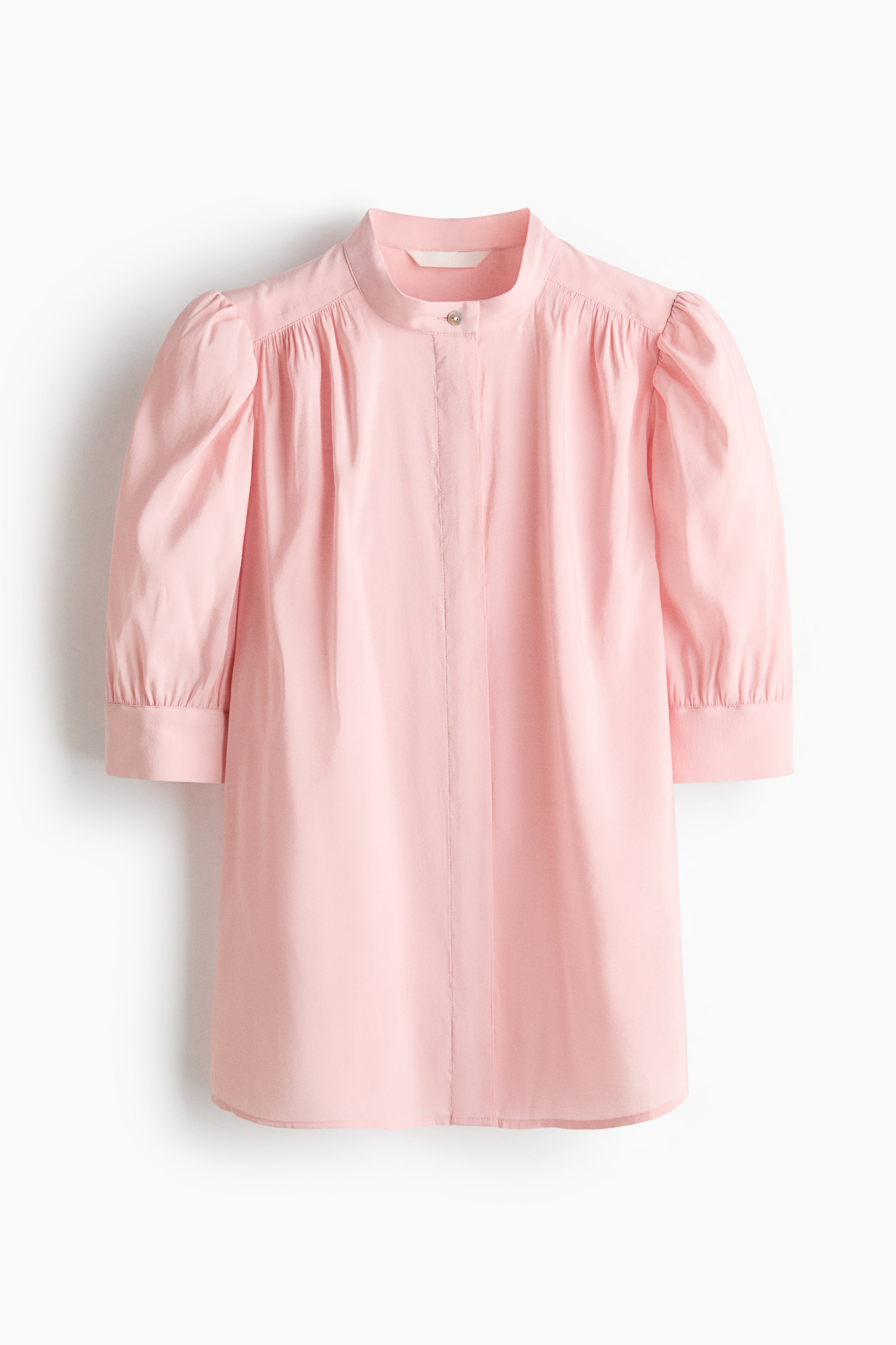 View larger image: A pink blouse is facing FRONT, featuring a band collar and a concealed button placket with one visible silver button at the top. It is designed with three-quarter-length puffed sleeves, gathered at the shoulders, and ending in buttoned cuffs.