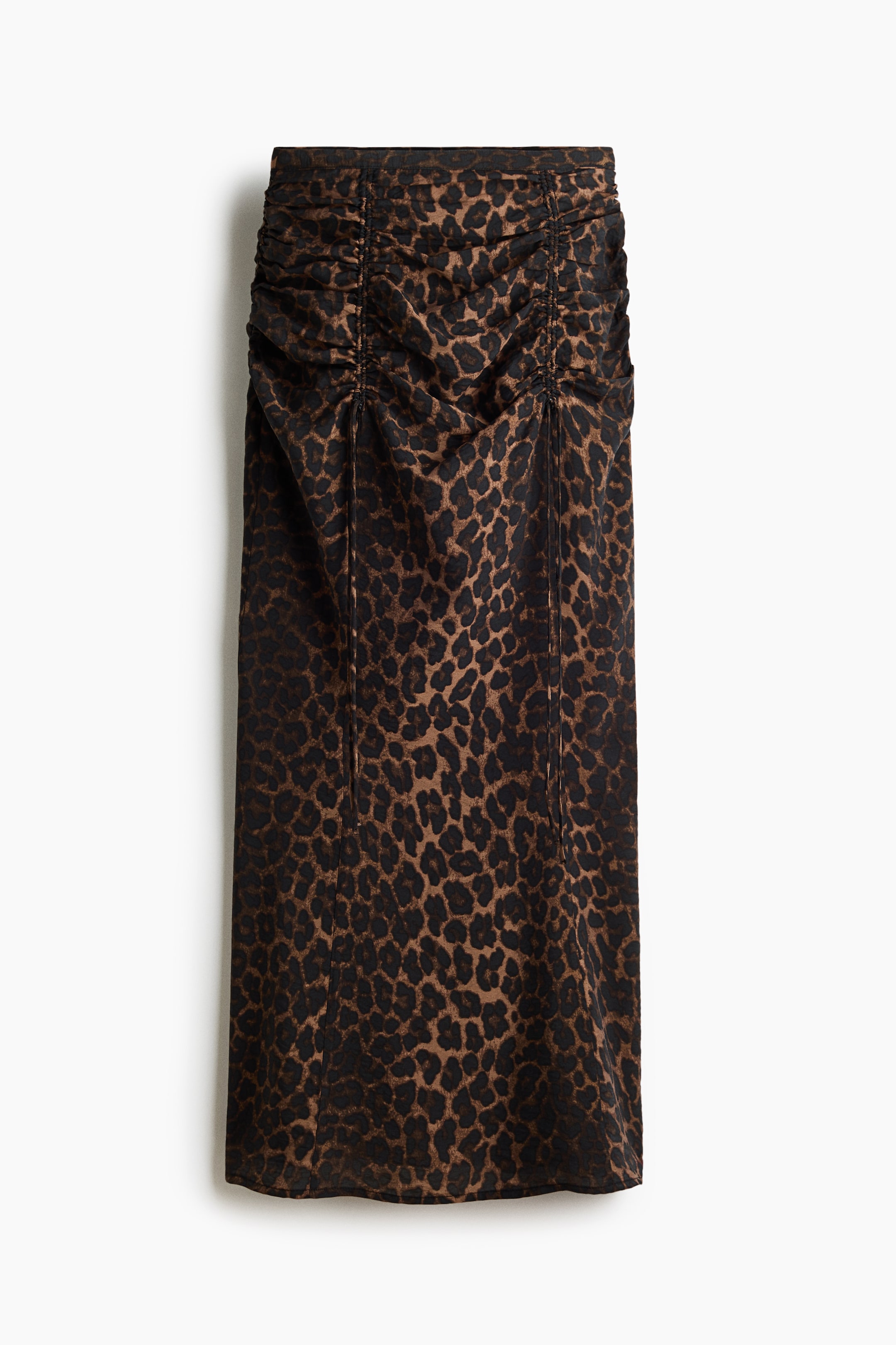 View larger image: A leopard print skirt is displayed front-facing, showcasing ruched detailing across the upper front that creates vertical gathers.