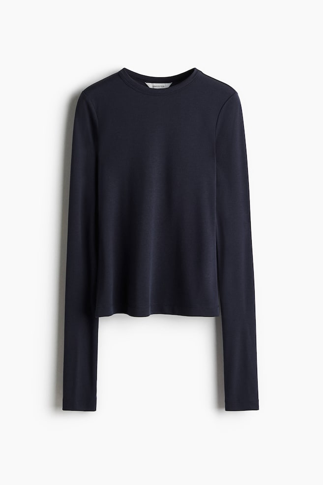 A dark blue long-sleeved top is shown from the front, featuring a crew neck and a slightly cropped, straight hem. - 1