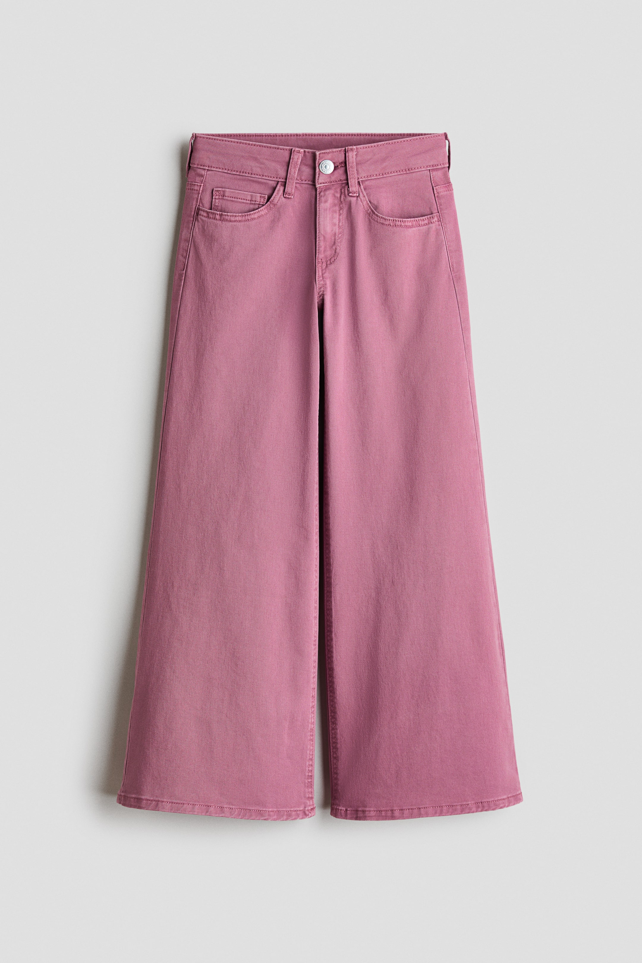 Größeres Bild ansehen: Mauvefarbene, weit geschnittene Hosen liegen flach und zeigen eine hohe Taille mit Gürtelschlaufen, einem Knopf- und Reißverschluss sowie zwei vorderen Eingrifftaschen mit einer kleinen Münztasche.