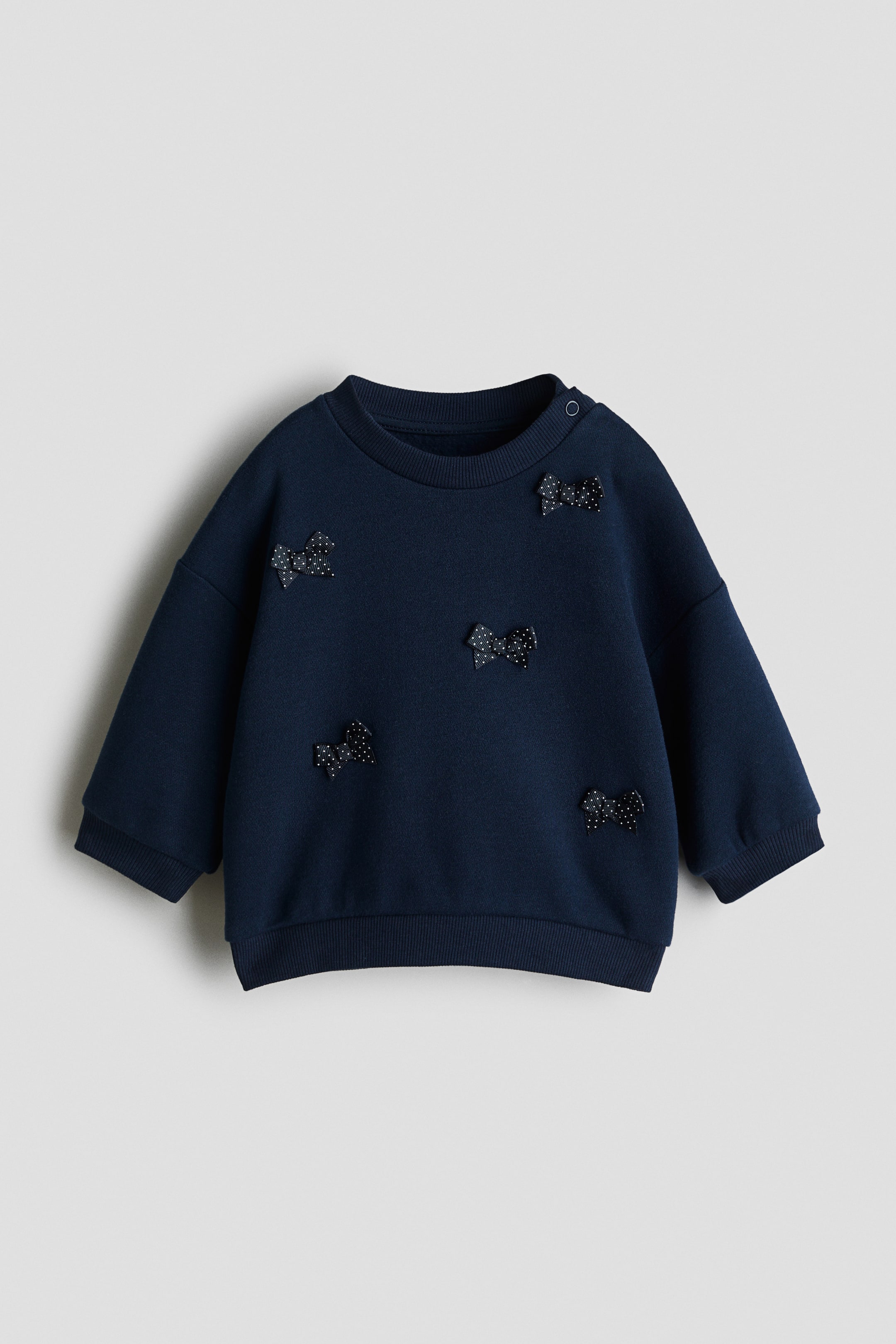 View larger image: Motif-detail sweatshirt - Navy blue/Bows - Kids | H&M IN 1