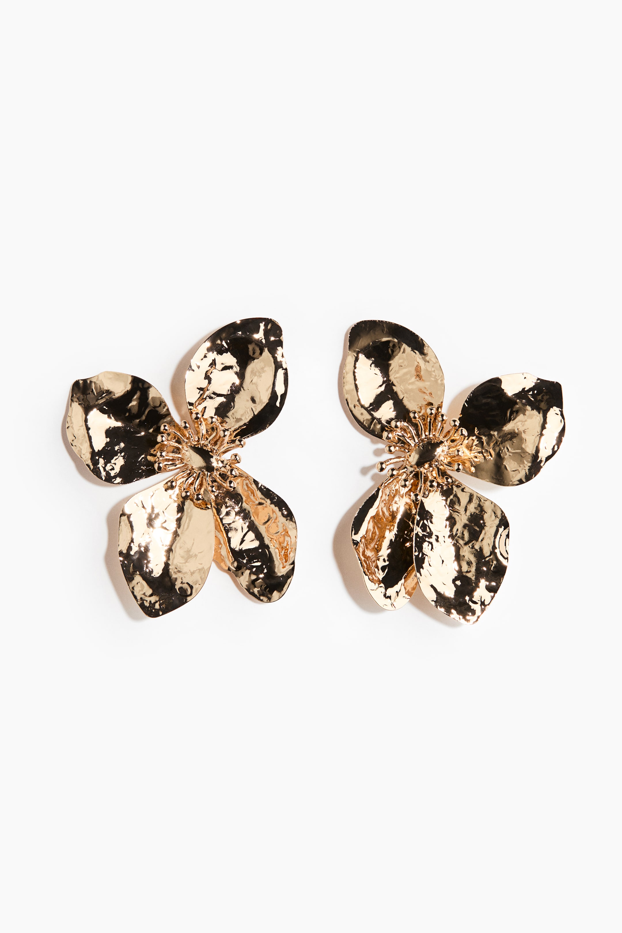 View larger image: A pair of gold-toned earrings features a flower design, each earring composed of four hammered petals surrounding a textured centre.