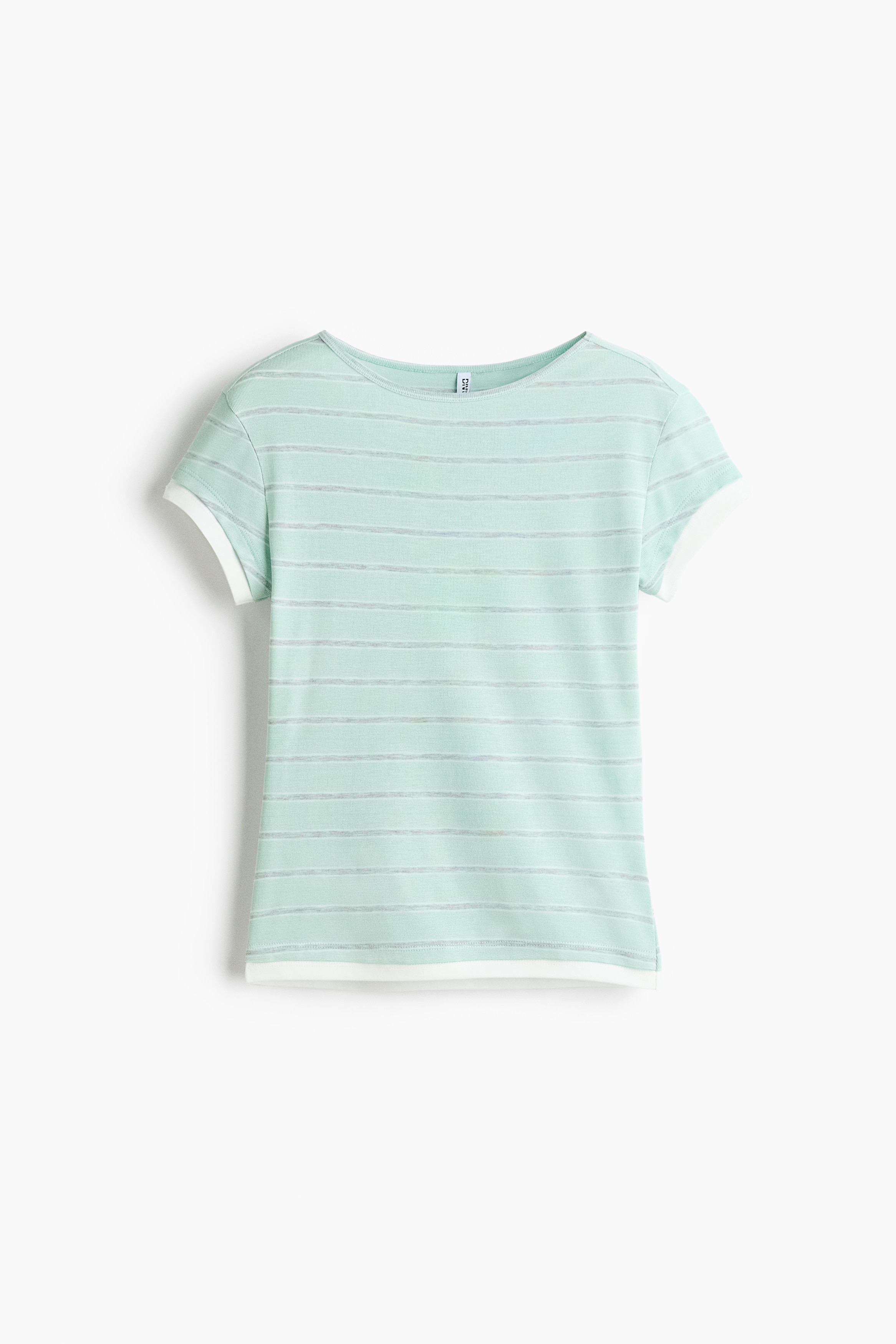 A light green and grey horizontally striped crew-neck T-shirt with white contrast trim is being worn by the model. The short-sleeve T-shirt is styled with low-rise blue denim jeans layered over a grey waistband.