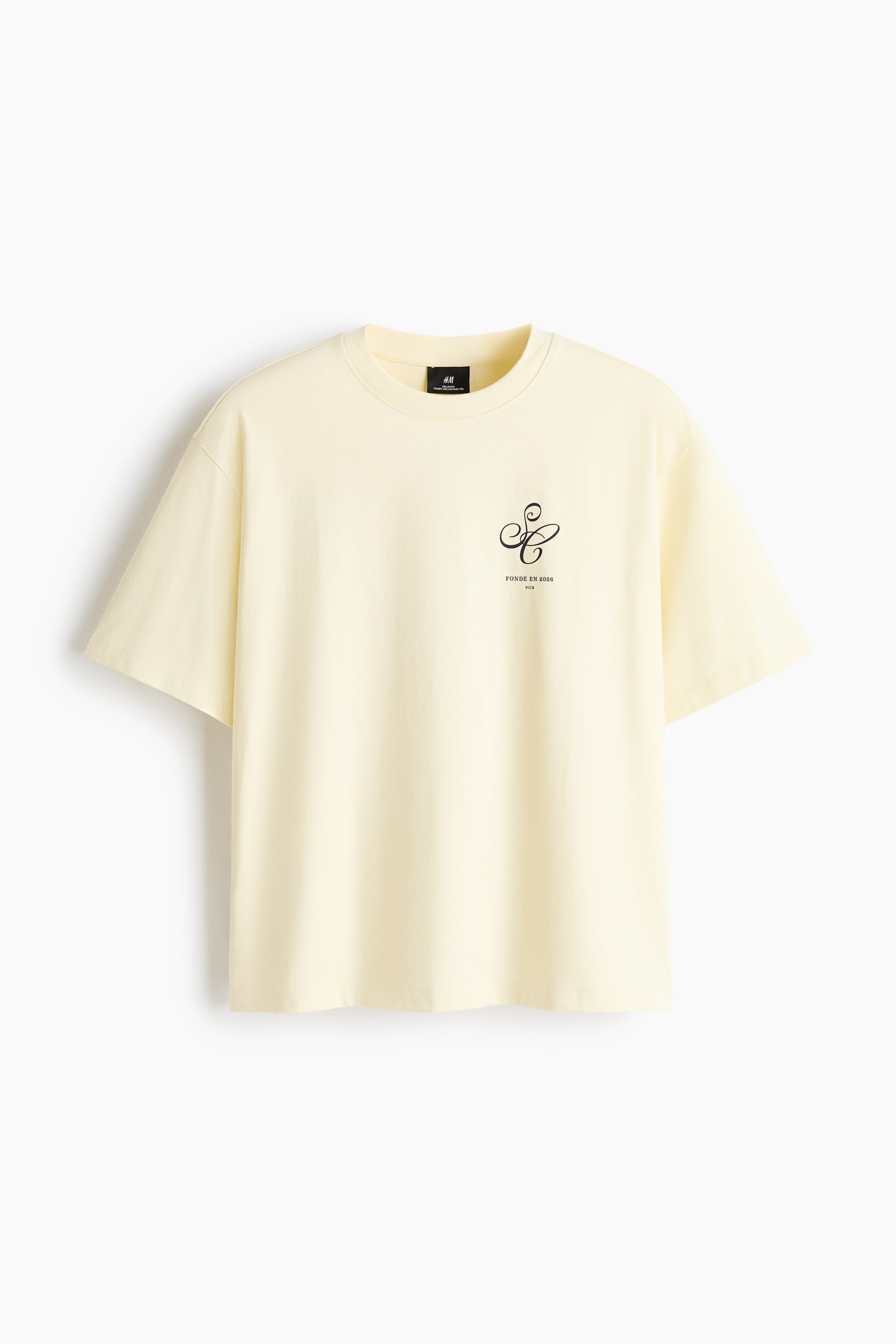 View larger image: A light yellow T-shirt crafted from soft, printed jersey is showcased from the front. It features a round, ribbed neckline, dropped shoulders, a straight-cut hem, a black graphic print on the chest, and a relaxed fit.