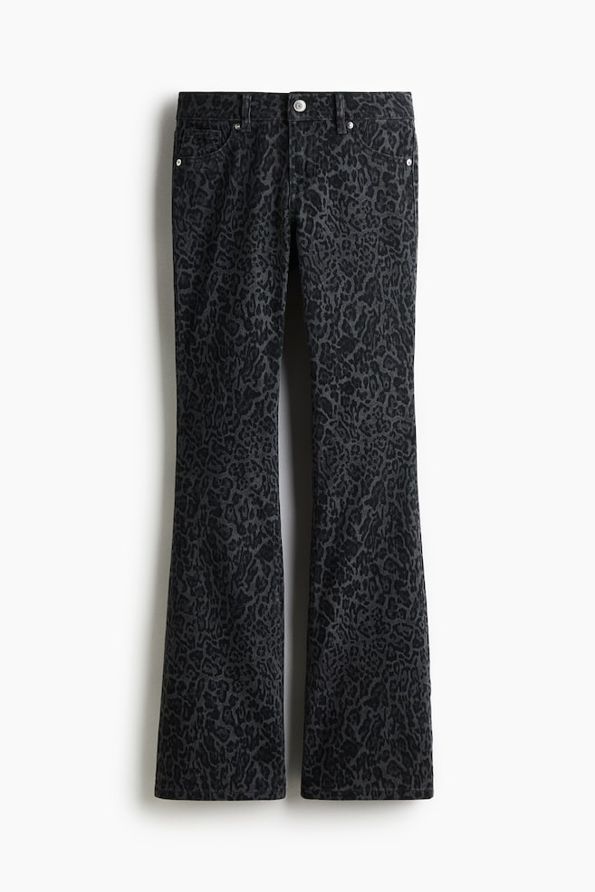 Jeans are displaying as FRONT, featuring dark grey denim with a subtle leopard print. They are designed with a low waist, a slim fit through the thigh, and a flared cut from the knee to the hem, with a visible button and zip fly closure, and front pockets including a coin pocket. - 1