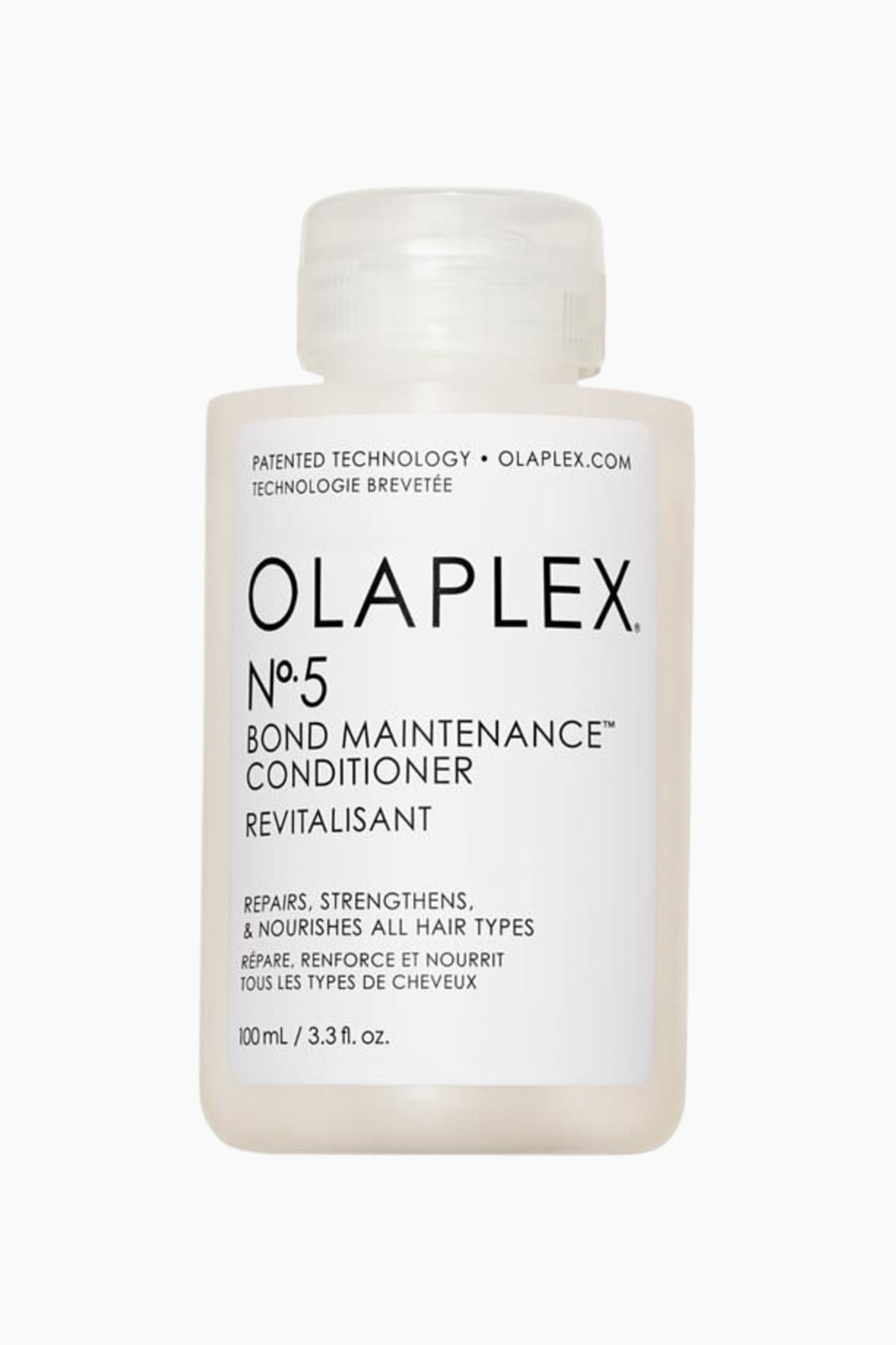 Vis større bilde: En Olaplex No. 5 Bond Maintenance Conditioner-flaske står oppreist, vendt fremover. Den har en gjennomskinnelig hvit rektangulær kropp med en klar flip-top kork, og en hvit etikett viser produktnavn, volum og fordeler i svart tekst.