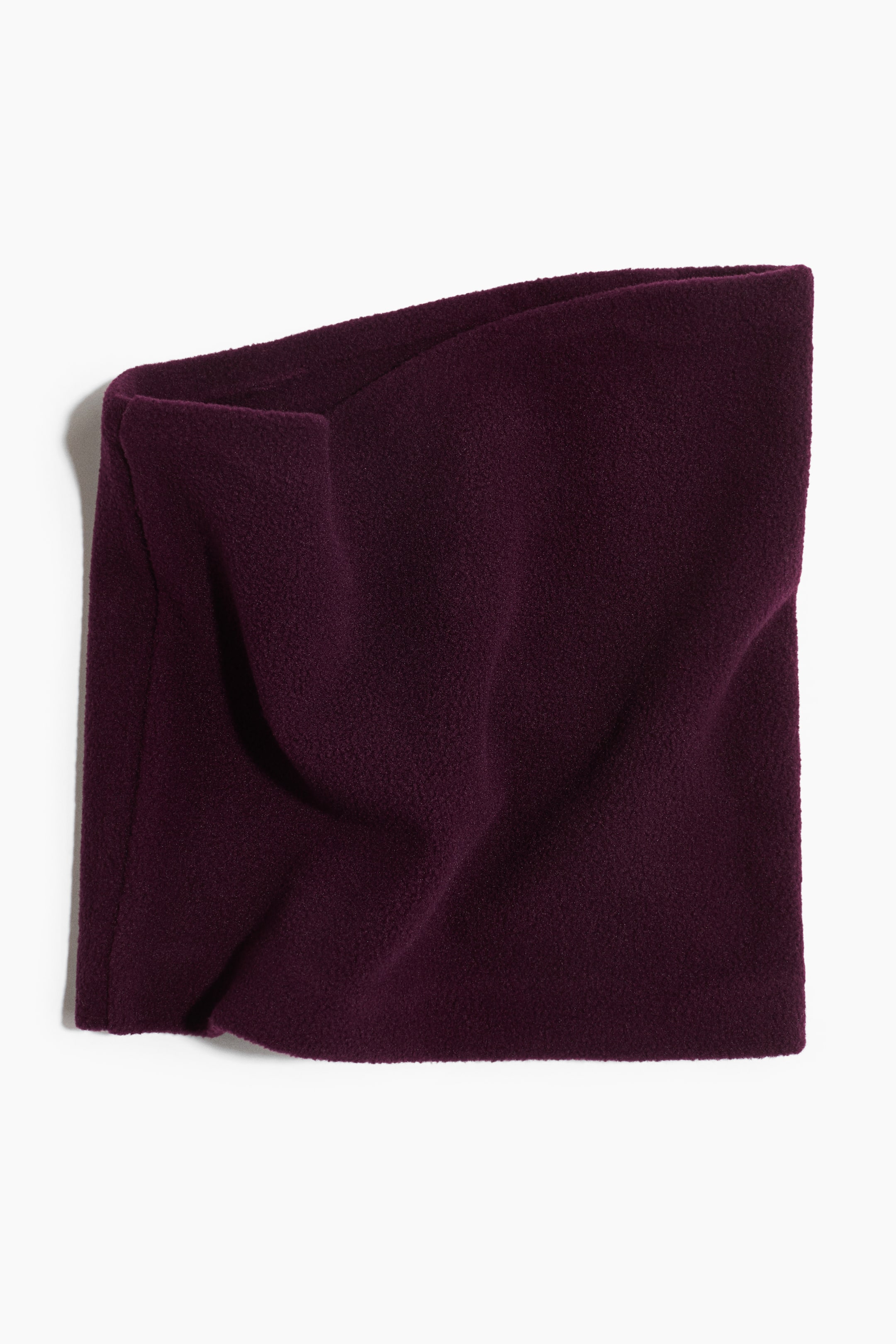View larger image: Neck warmer in dark purple fleece showcases its soft texture with gentle drapes and folds.