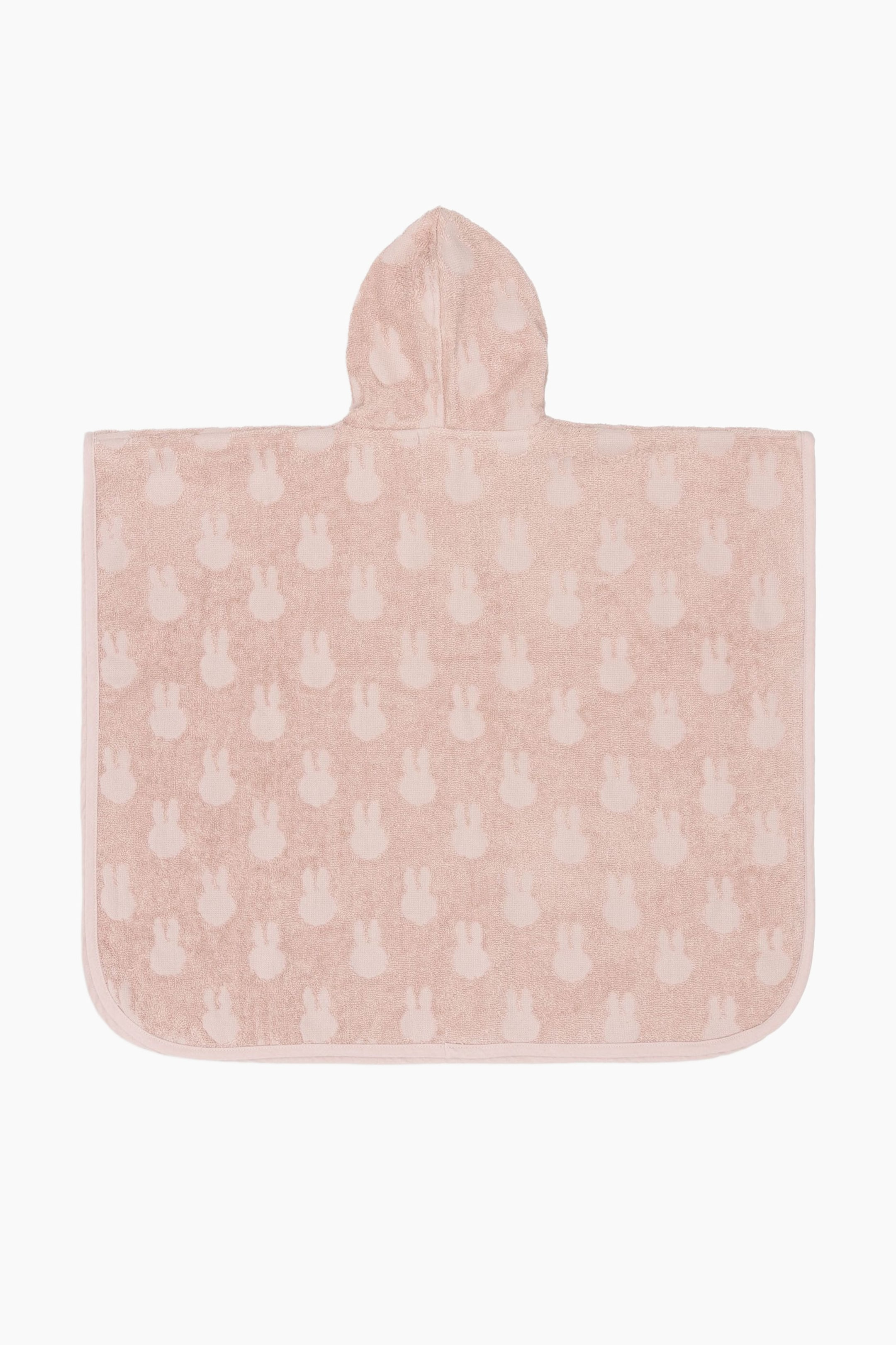 View larger image: A light pink hooded towel poncho is lying flat, showcasing a tone-on-tone pattern of repeated bunny shapes. It is designed with a rectangular body, rounded bottom corners, and a central hood at the top.