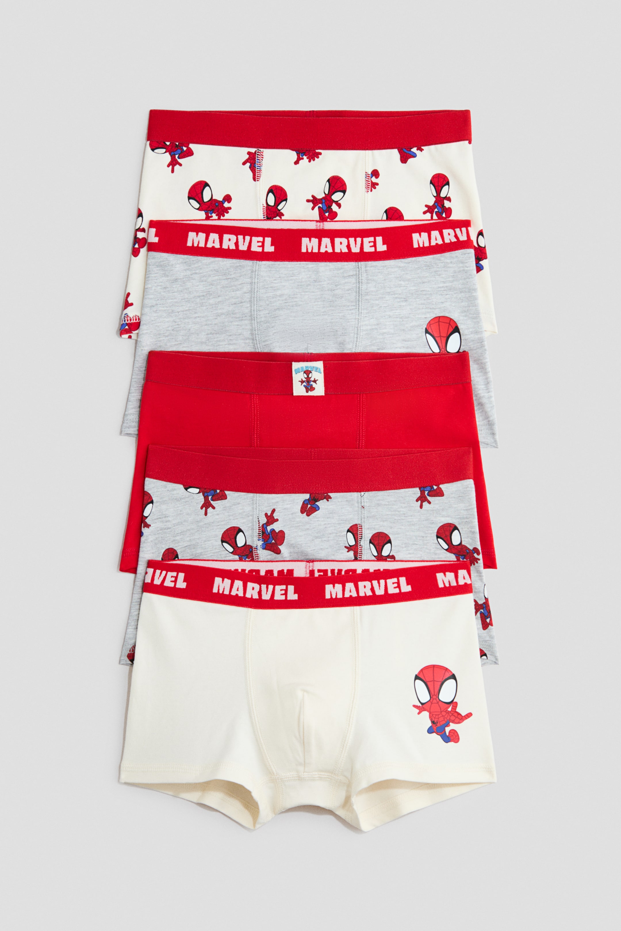 Größeres Bild anzeigen: Fünf Boxerbriefs aus Baumwolljersey sind vertikal gestapelt und zeigen ihre Vorderseite mit kurzen Beinen und elastischen roten Bundabschlüssen. Das Sortiment umfasst Varianten in einfarbigem Rot, Grau und Off-White, verziert mit Spider-Man-Grafiken und dem Schriftzug „MARVEL“ auf den Bundabschlüssen.