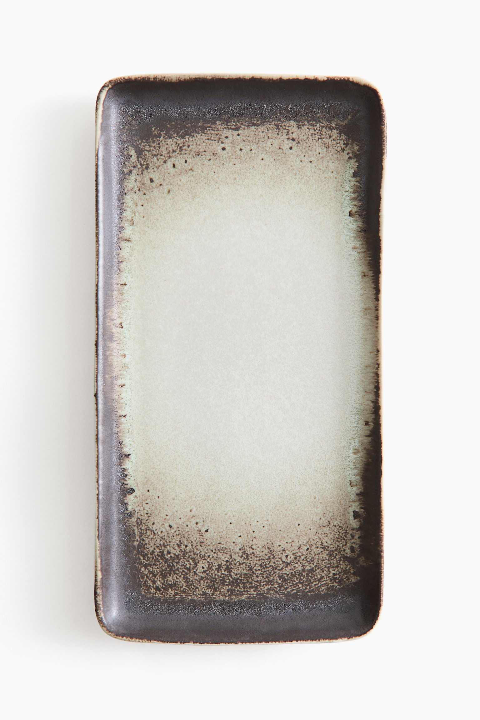A rectangular ceramic platter is displayed from a front-facing angle, showcasing a reactive glaze design with a light beige centre transitioning into a dark brown, speckled border. The platter features rounded corners and a slightly raised rim with a textured gradient effect.