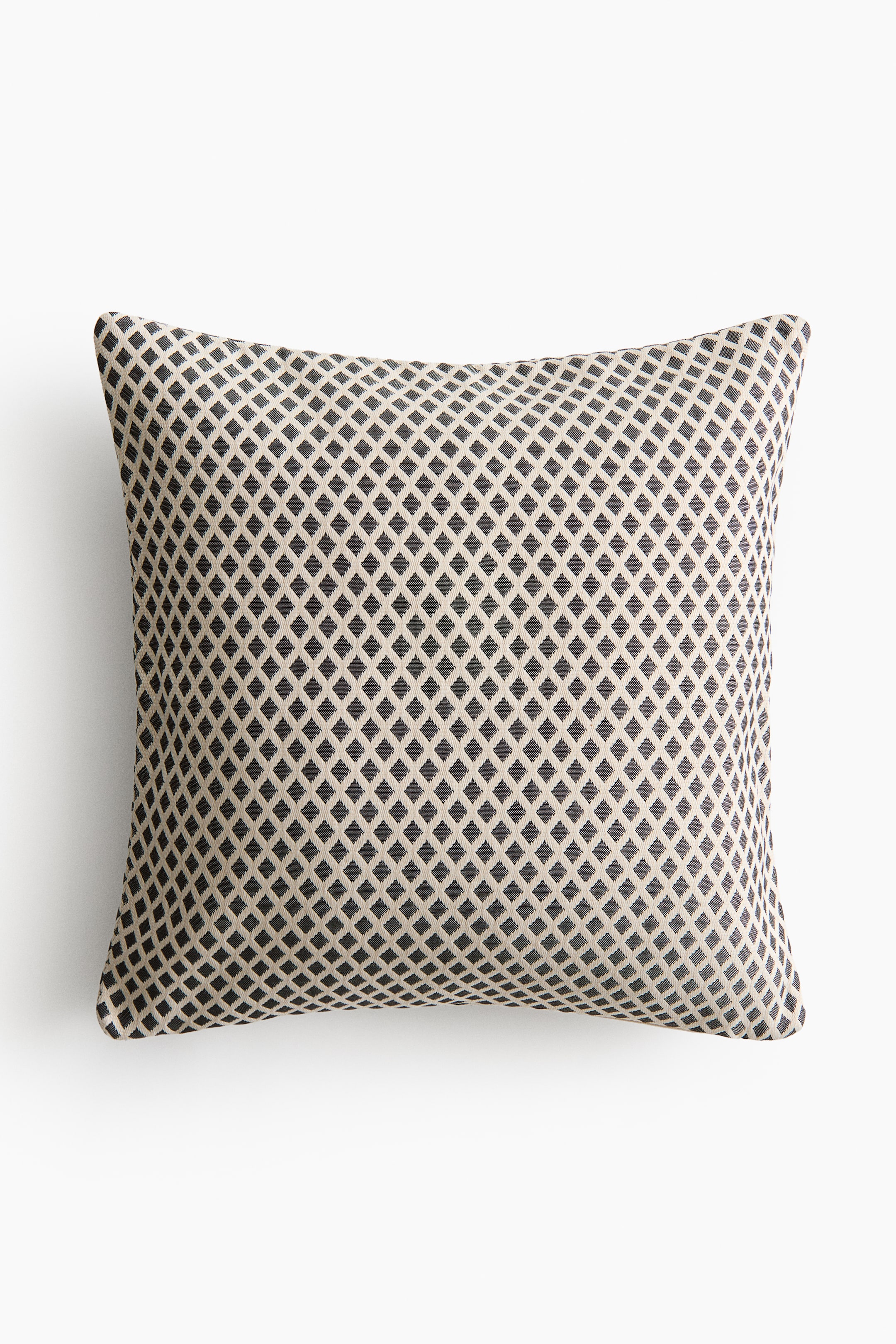 View larger image: The cushion showcases its front side, highlighting a dark charcoal diamond pattern set against a light beige backdrop.
