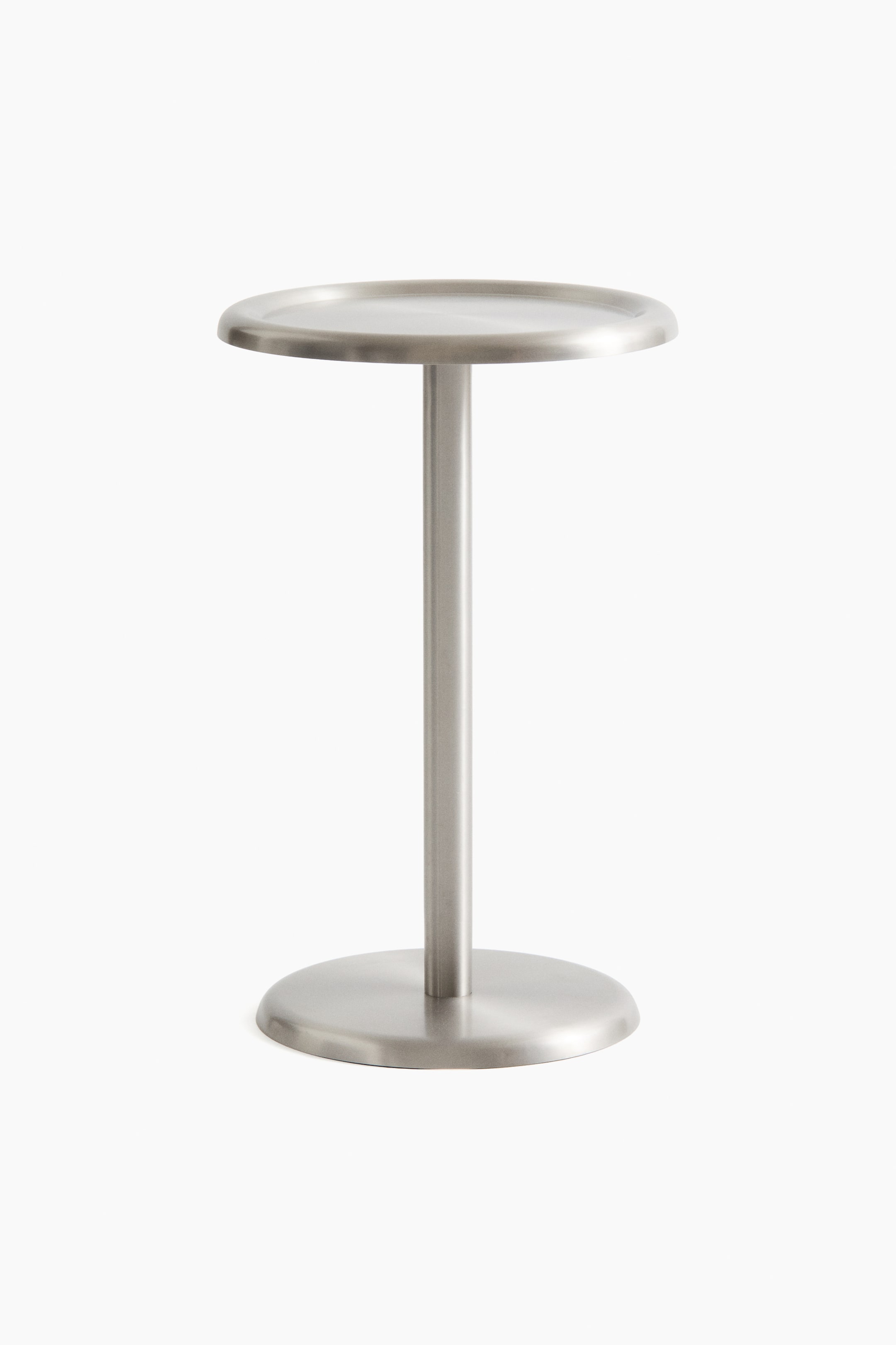 View larger image: A brushed stainless-steel stand features a flat, round top with a slightly raised edge, a slender, cylindrical column, and a wider, round base with a slightly raised edge.