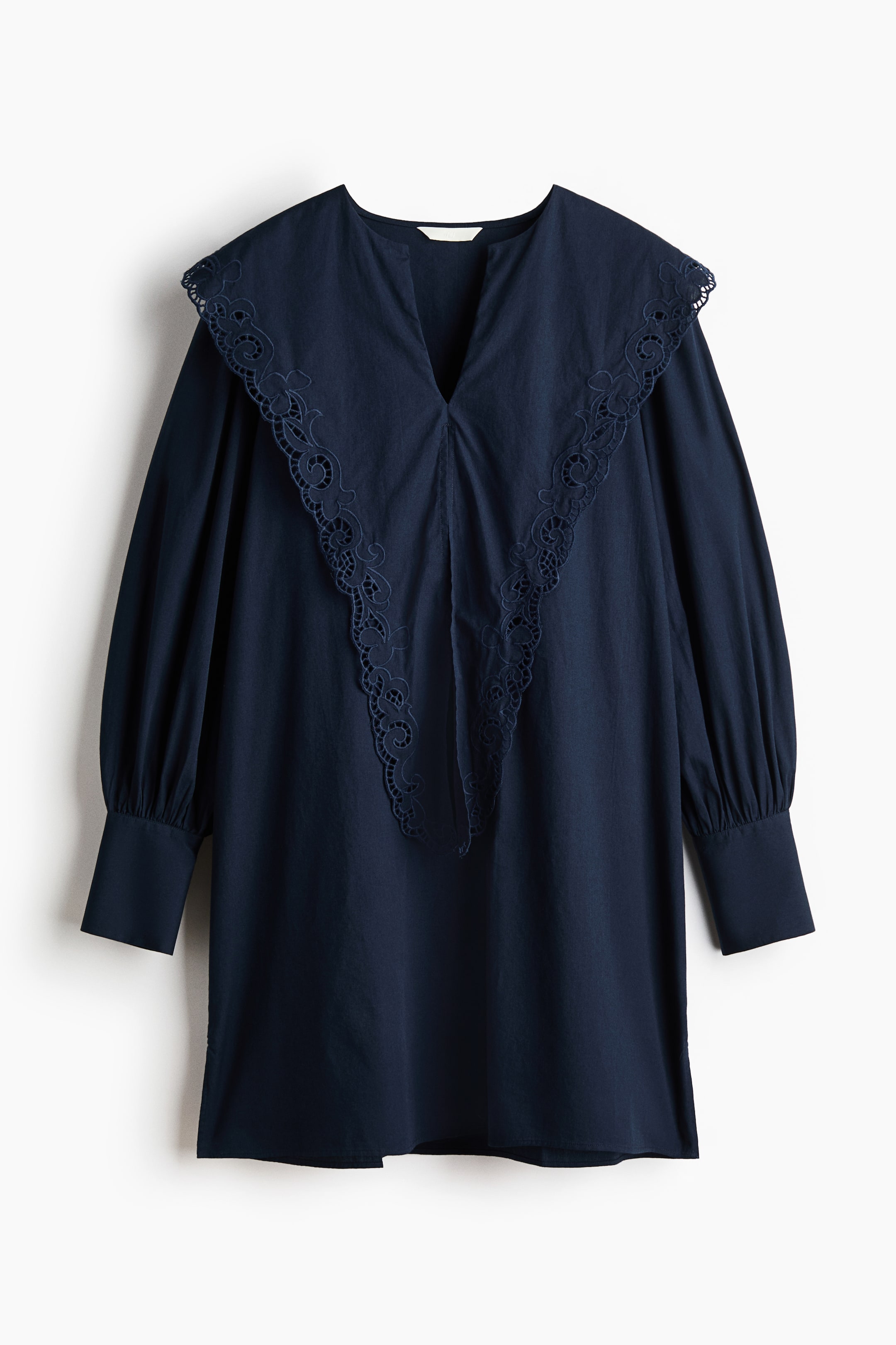 View larger image: A deep blue tunic showcasing a broad, flat collar adorned with broderie anglaise detailing, extending gracefully over the shoulders and accentuating a V-neck. Crafted with long, voluminous sleeves that gather into wide cuffs, it offers a relaxed front fit.