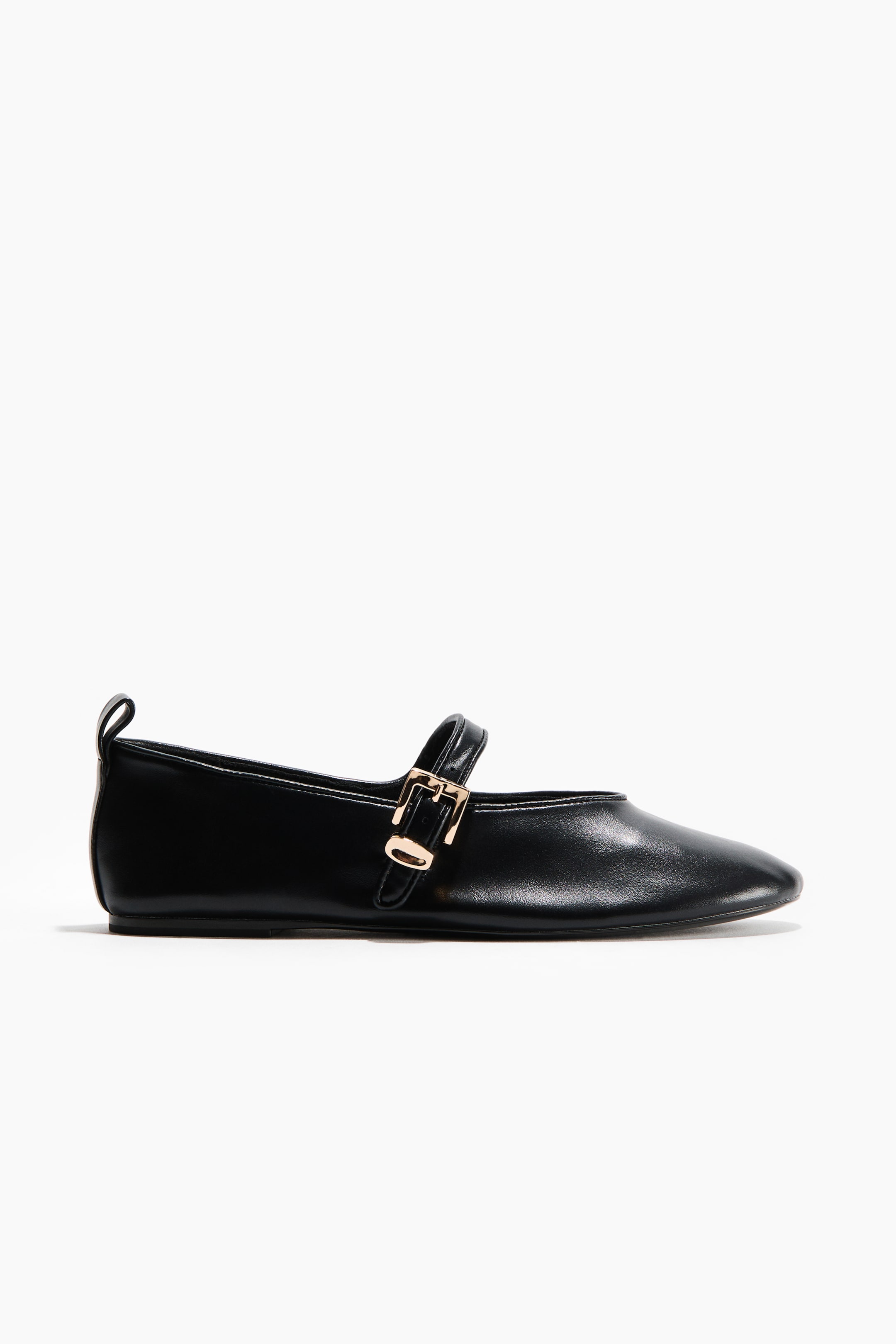 Ver imagen más grande: Un zapato plano tipo Mary Jane en color negro presenta un material liso con una punta sutilmente afilada. Una única correa asegura el empeine con una pequeña hebilla rectangular en tono dorado, y una lengüeta es visible en el talón trasero.