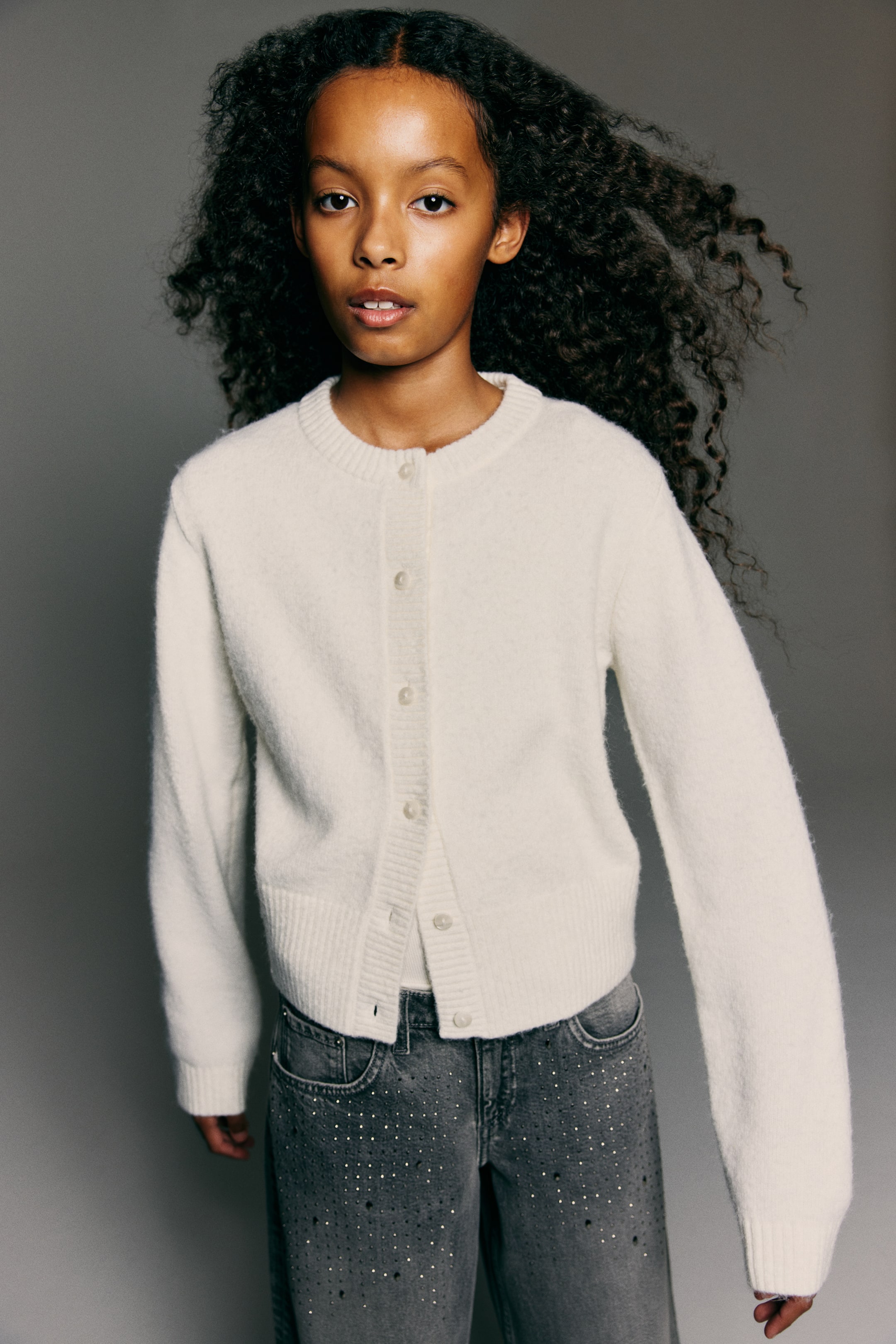 View larger image: The 5-pocket jeans are featured from the FRONT in a washed-out cotton denim, with a low waist, zip fly, and button closure, and a relaxed fit through the hip, thigh, and leg.