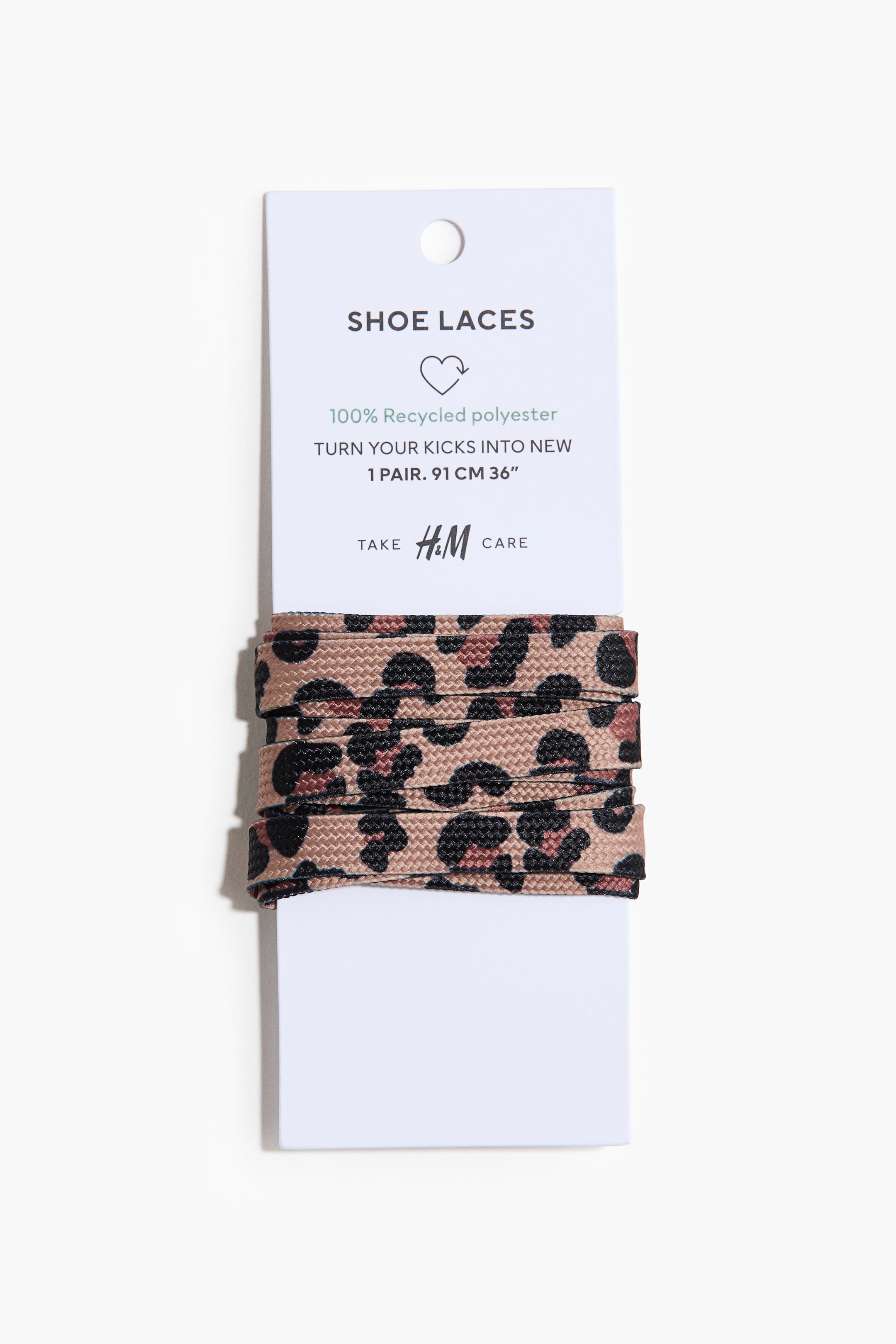 View larger image: A pair of flat shoelaces, 91 cm long, features a beige, black and brown leopard-print pattern. The laces are wrapped around a white cardboard backing card, which displays product details including their 100% recycled polyester material.