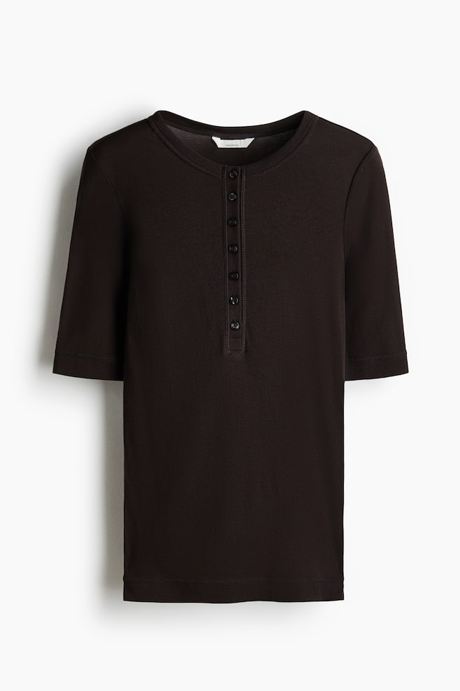A dark brown henley shirt is shown from the front, featuring a round neckline and a six-button placket. It has short sleeves and a straight hem. - 1