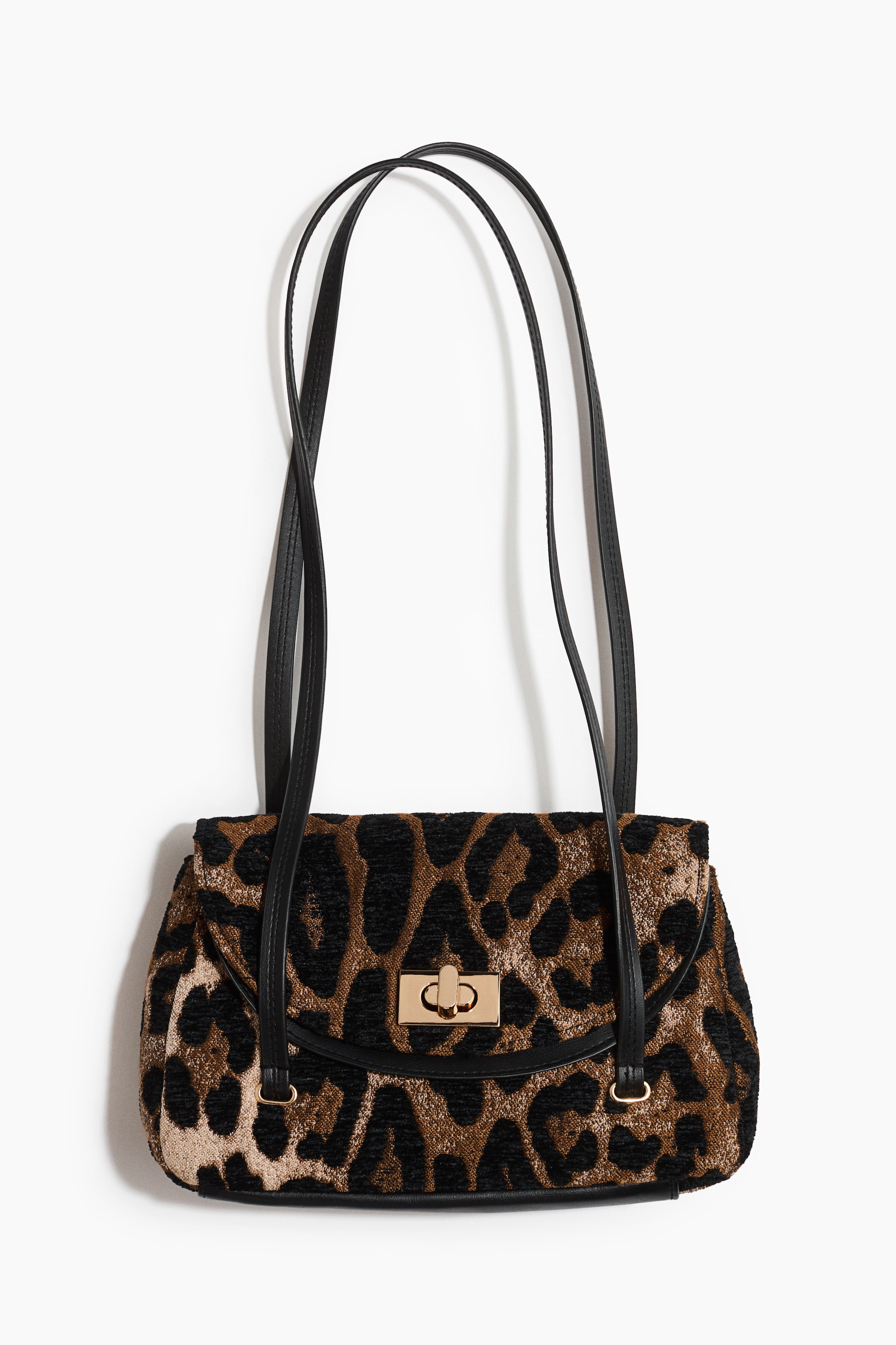 View larger image: A leopard-print shoulder bag is hanging, showcasing its design from the front with two long, narrow black shoulder straps. The bag displays a curved front flap with a layered look and a gold-toned metal twist-lock fastener.