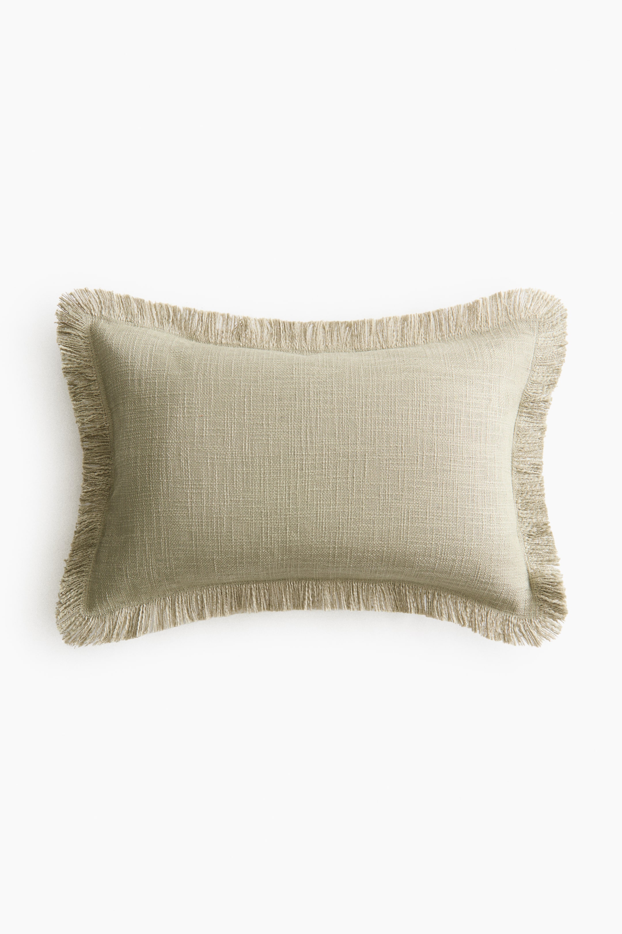 Voir une image plus grande: Une housse de coussin présente son DEVANT, avec un tissage en coton slub beige clair et des franges le long des quatre bordures.