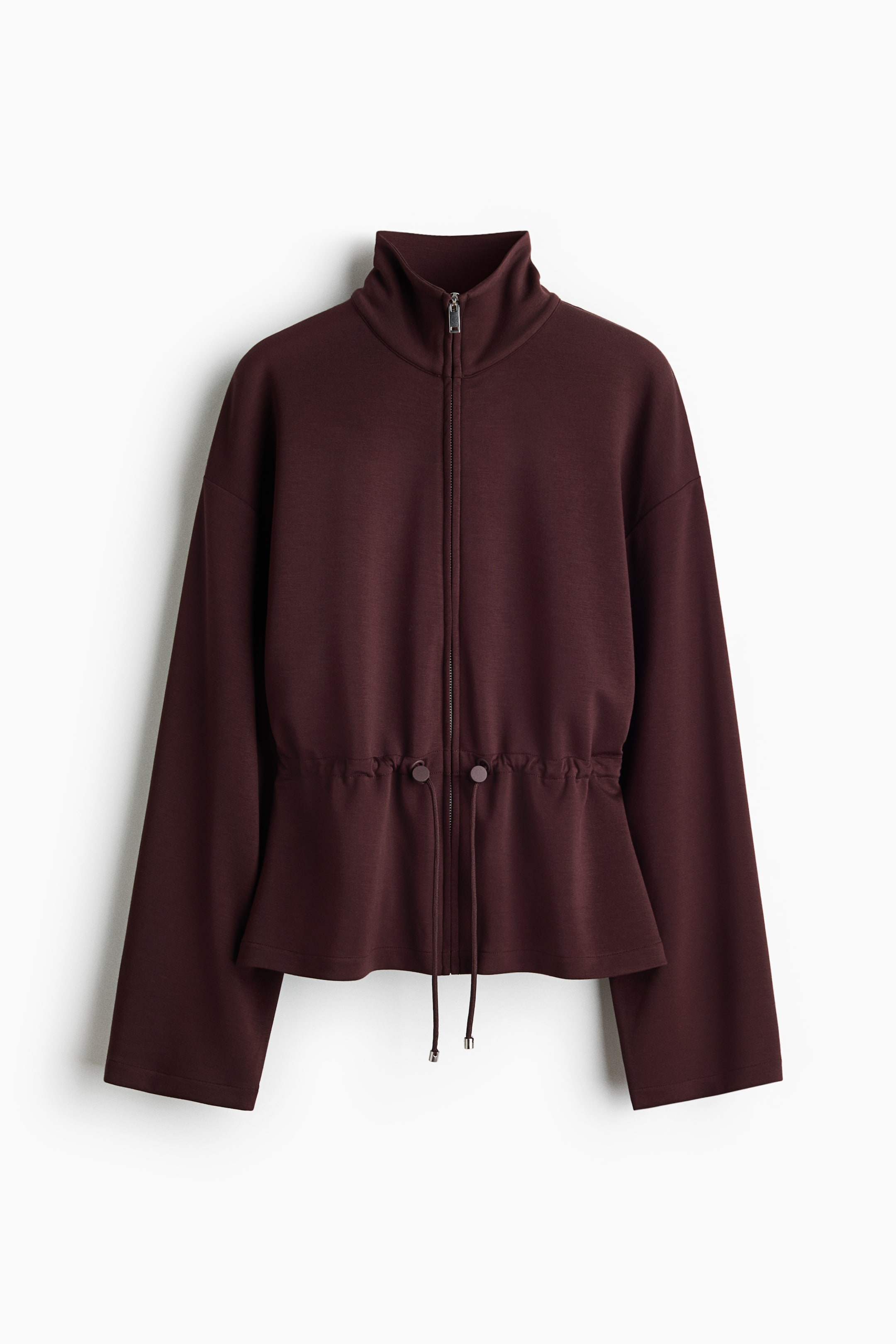 View larger image: A burgundy jacket faces forward, showcasing a high-neck collar and a full-length front zipper. The drawstring waist, equipped with two toggle stoppers, cinches the jacket's silhouette, while wide long sleeves extend from the shoulders.
