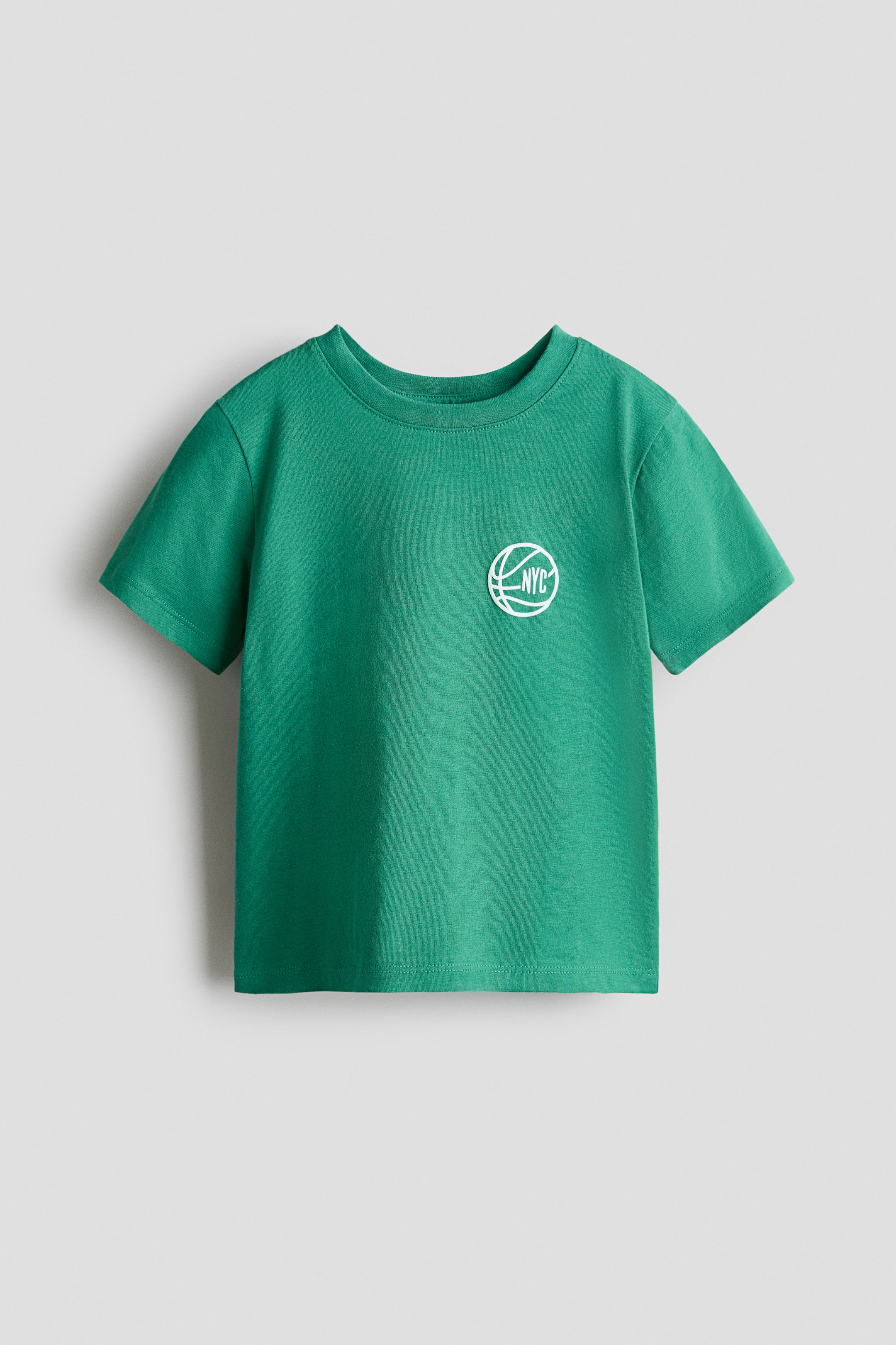 View larger image: A green T-shirt in soft cotton jersey is shown from the front, featuring ribbing around the neckline, dropped shoulders and a straight-cut hem. A white circular graphic depicting a basketball with "NYC" is visible on the left chest.