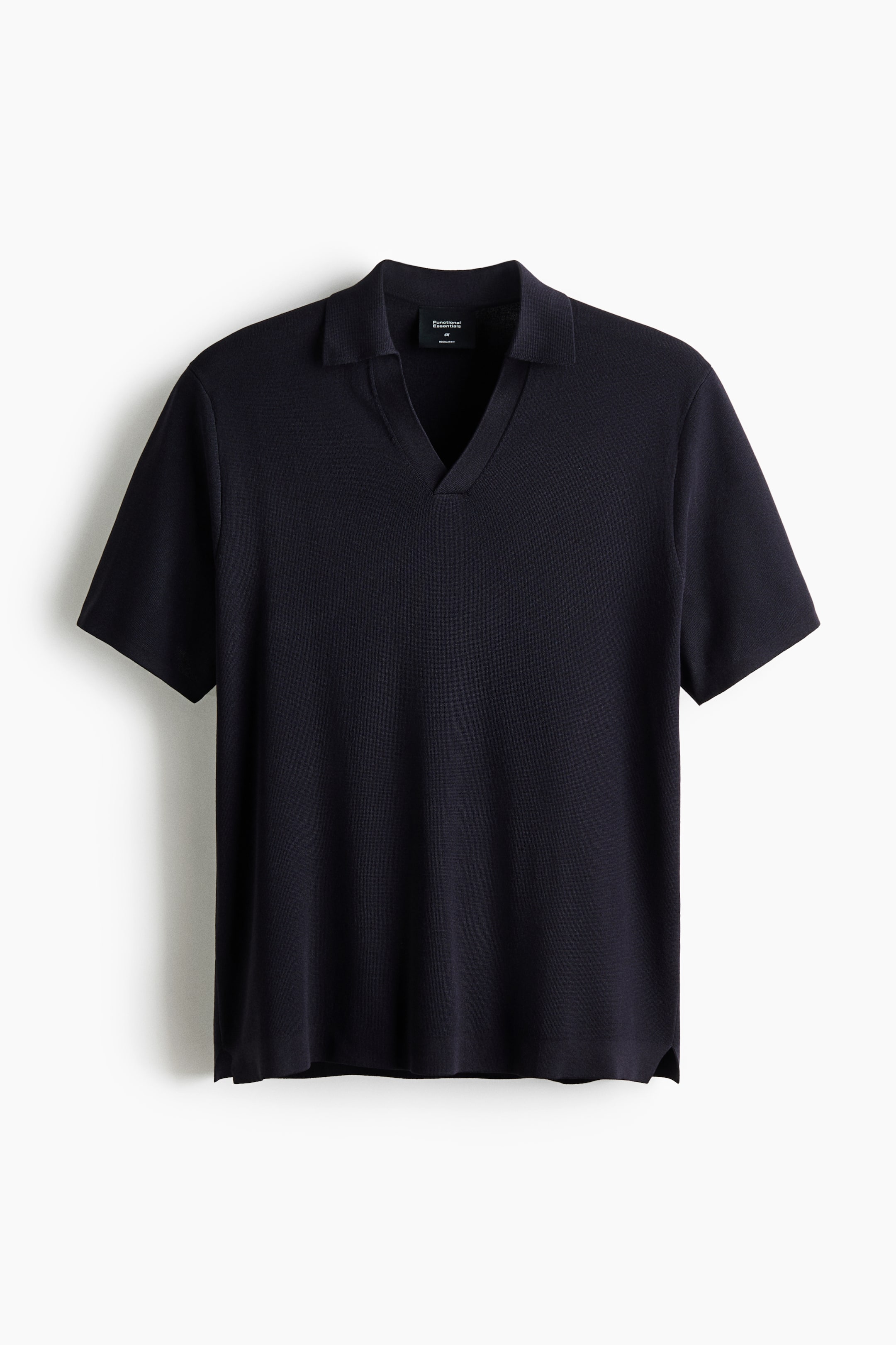 View larger image: A dark blue knitted polo shirt is displayed front-facing, featuring a spread collar, a V-neck placket, and short sleeves. The shirt is finished with a straight hem and small side slits.