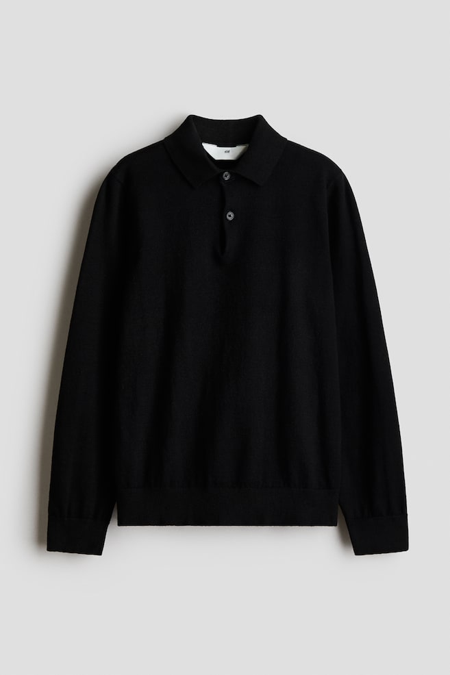 A black, long-sleeved knit polo sweater is facing front, featuring a classic collar, a two-button placket, ribbed cuffs, and a ribbed hem. - 1