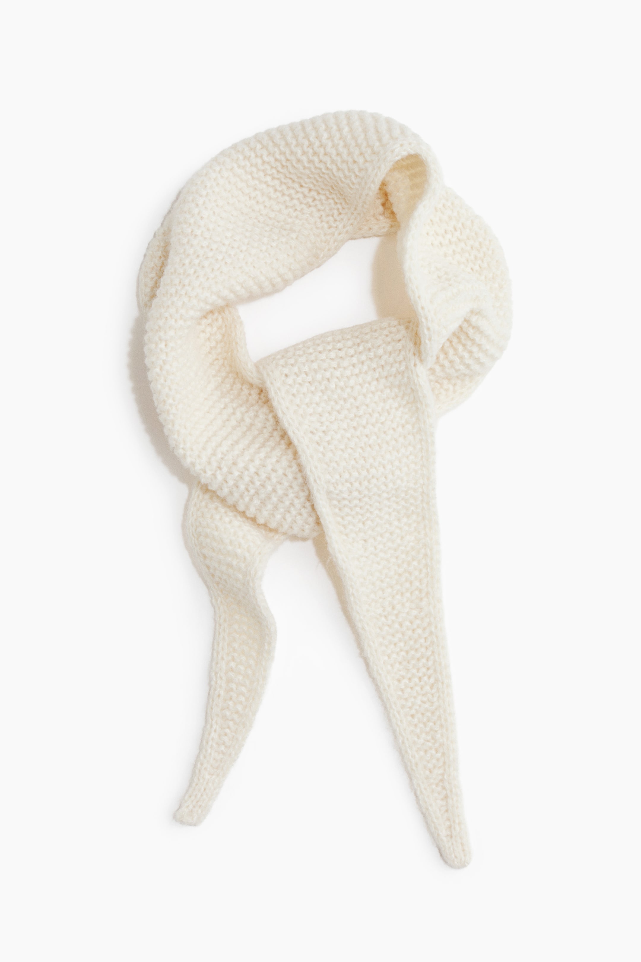 View larger image: A scarf features a soft, off-white garter stitch knit. It is loosely draped and looped, with its ends tapering to points.