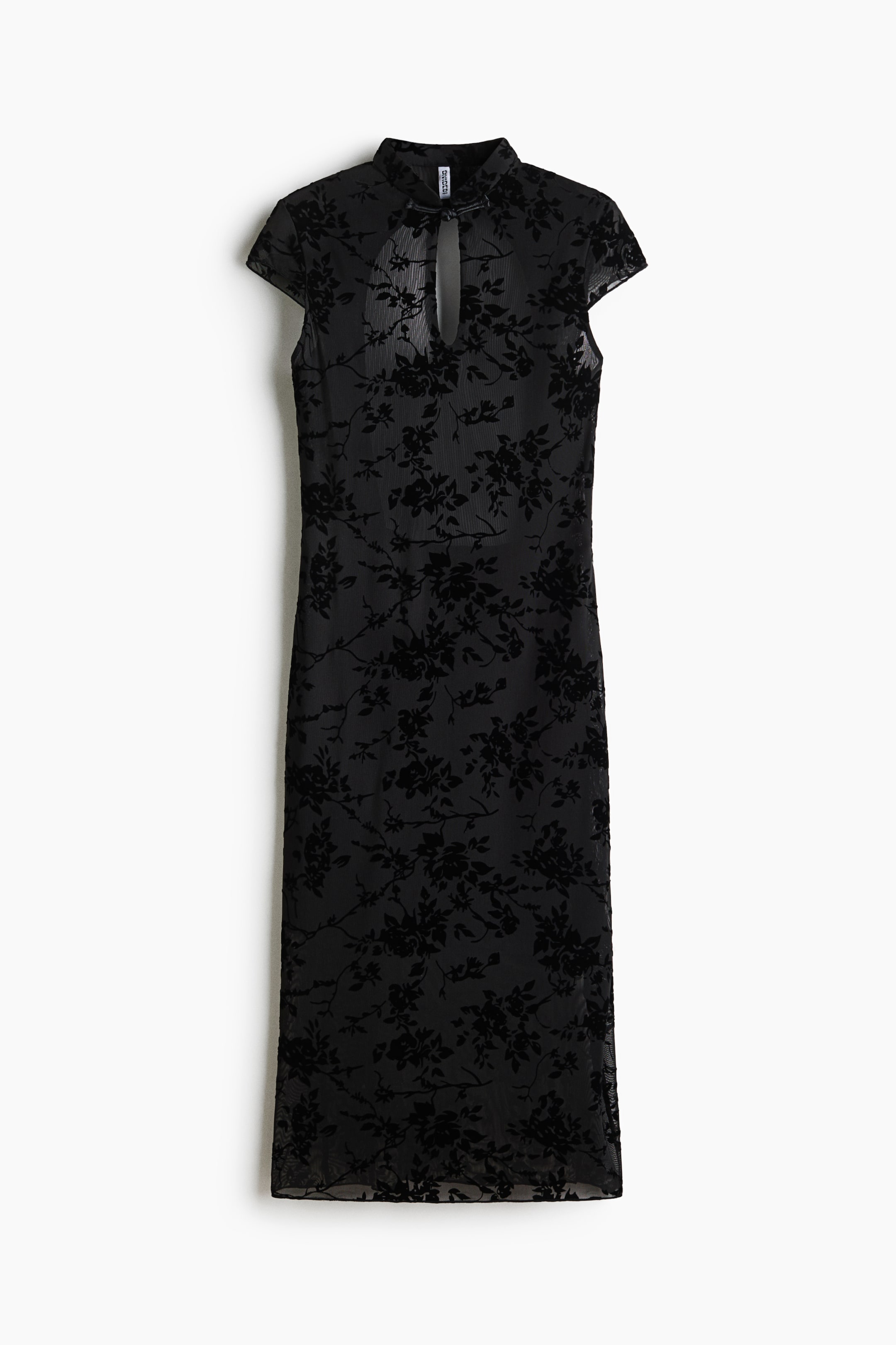 View larger image: A black midi dress is facing front, showcasing sheer mesh fabric with an all-over flocked velvet floral pattern. The dress features a high stand collar with a front keyhole opening, short cap sleeves, and a straight silhouette.