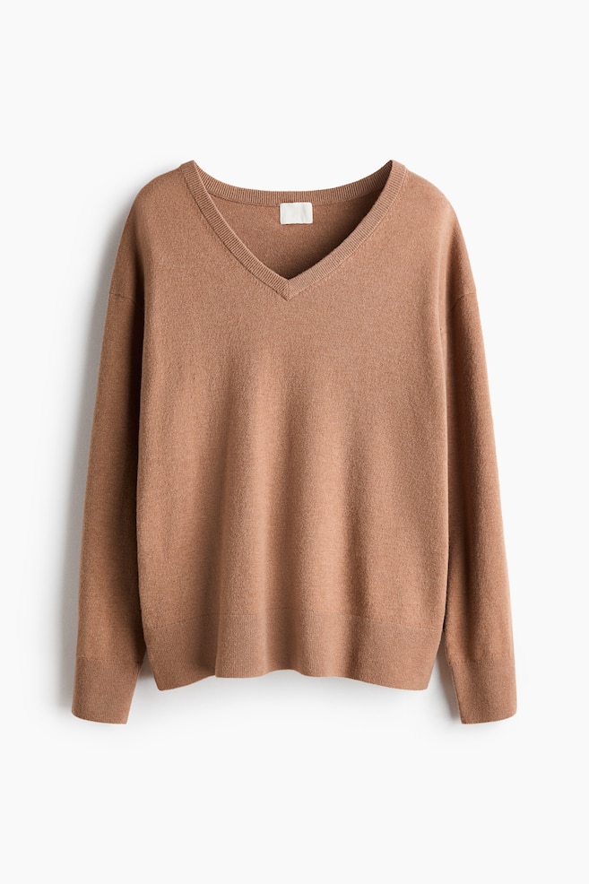 A camel brown V-neck sweater is facing forward, featuring long sleeves with ribbed cuffs and a ribbed hem. - 1