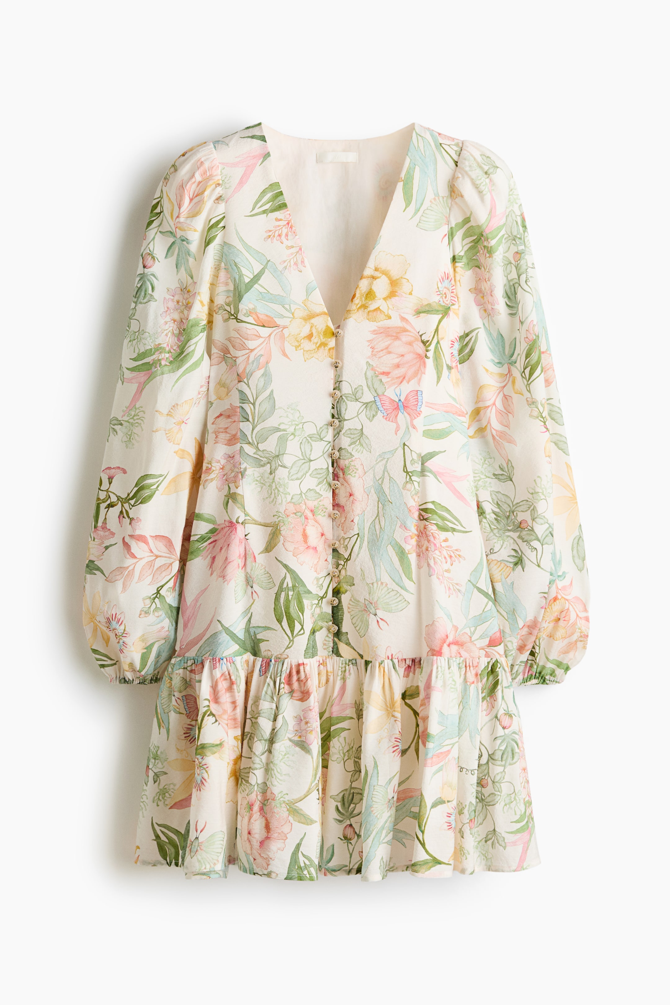 View larger image: A front view of a cream-coloured mini dress displays a vibrant floral and botanical print featuring pink, green, yellow and blue flowers and butterflies. It features a V-neckline, button-front closure and long balloon sleeves with elasticated cuffs, gathered at a ruffled, tiered skirt.