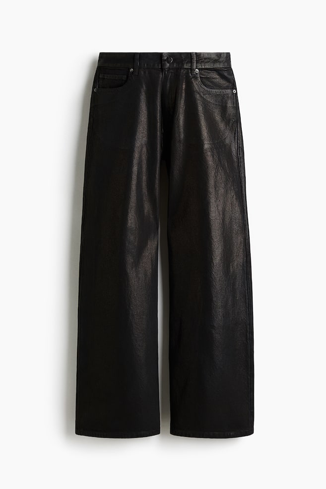 A pair of black, wide-leg pants is hanging, showing its front. It is made of a slightly textured, coated or faux leather material and features a button closure, belt loops, and front slanted pockets with rivets. - 1